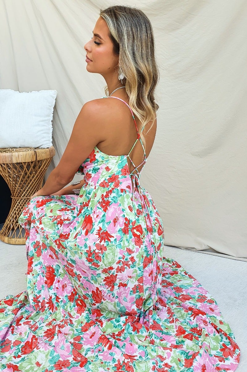 Model wearing floral print Swish Maxi Dress with V-neckline and adjustable tie straps, showcasing the back design.