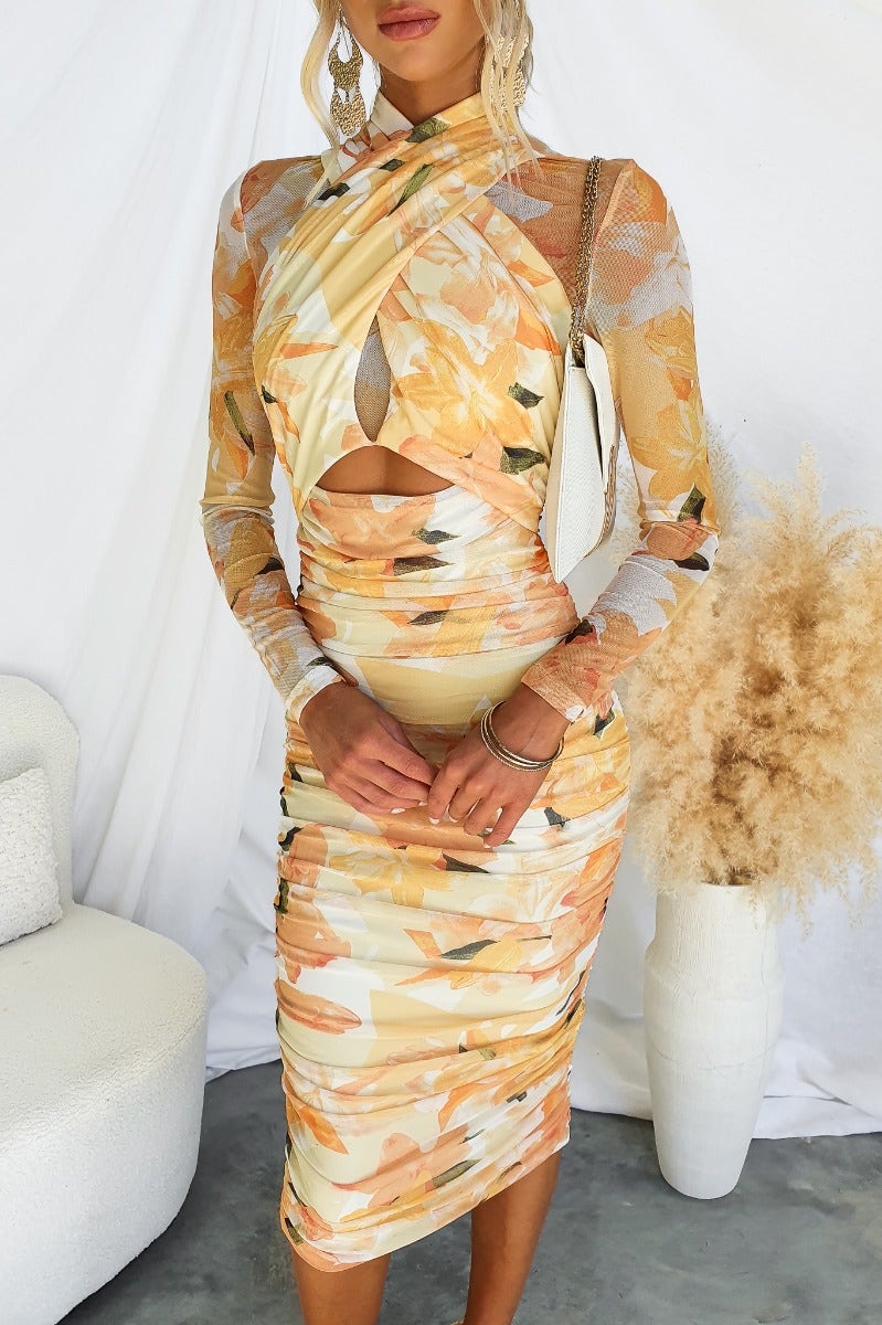 Thousand Miles Midi Dress featuring a cross-over bust and cut-out waist in floral print, perfect for stylish occasions.