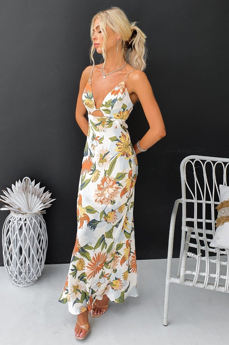 Elegant floral satin maxi dress with adjustable straps and cut-out details, perfect for summer occasions.