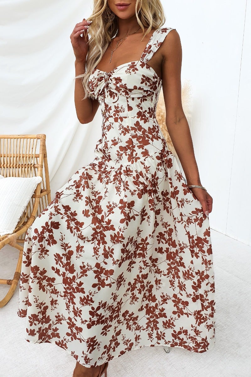 Heartbreak maxi dress featuring floral print, tie detail at bust, and flowy design, ideal for casual outings.