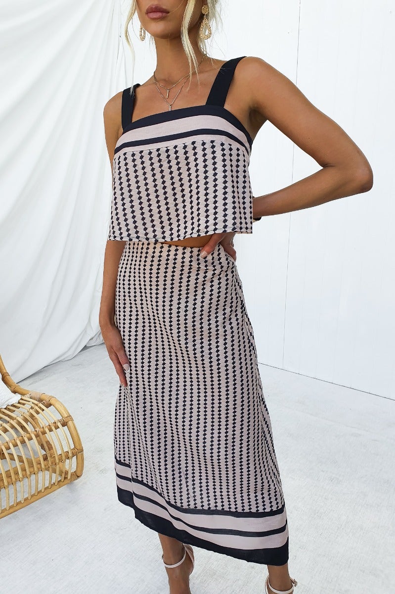 Model wearing Day By Day Set features a square neckline crop top and a mid-high waist midi skirt in a stylish print.
