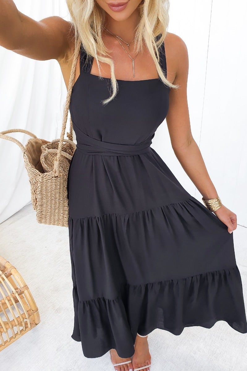 Stylish black Etsie maxi dress with adjustable tie halter neckline and tiered design, perfect for any occasion.