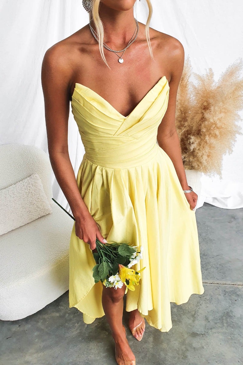 Strapless Kiss And Tell Maxi Dress in sunny yellow with pleated bodice and asymmetric hem, perfect for summer events.