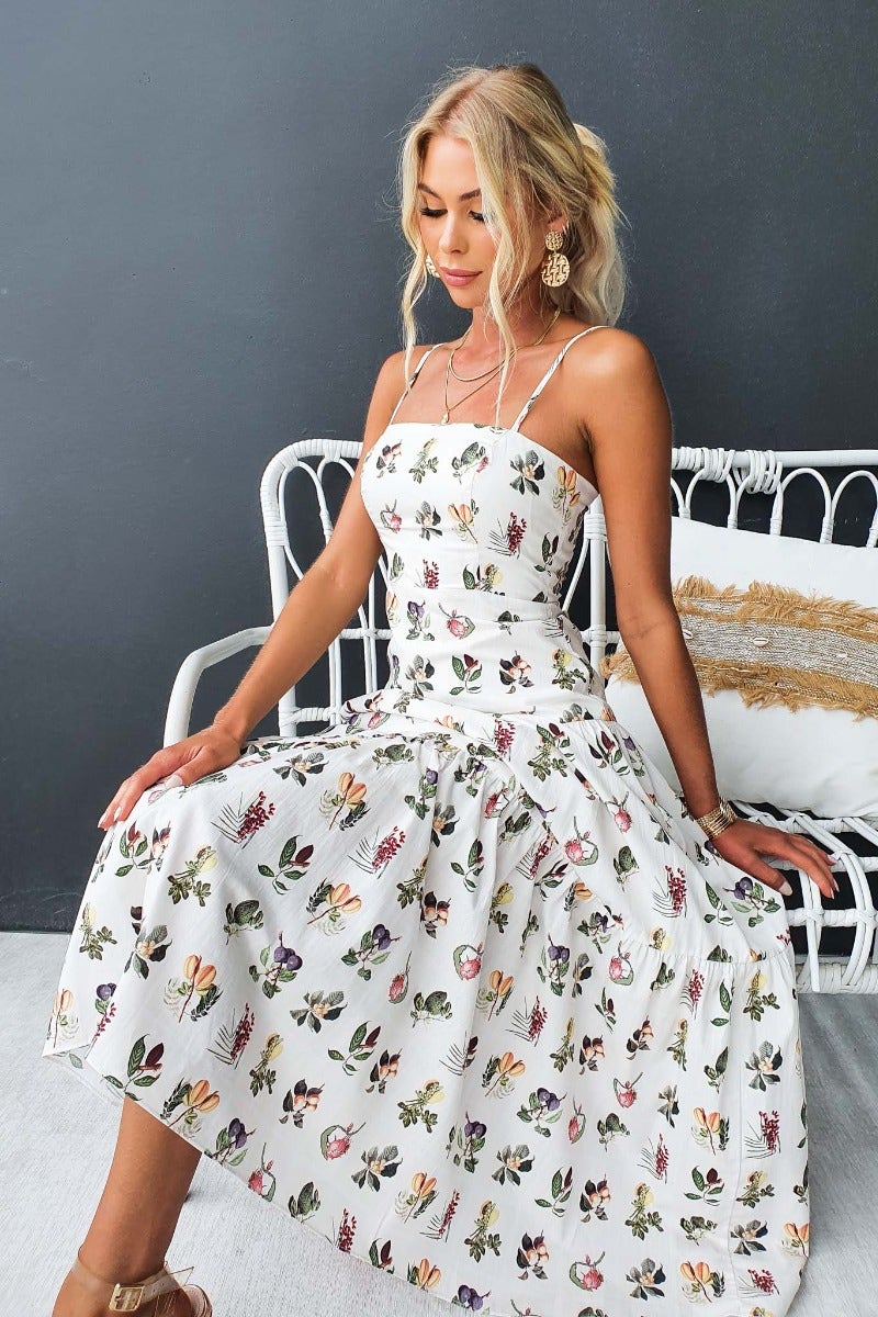 Carlyle Maxi Dress featuring floral print, adjustable straps, and a stylish silhouette, perfect for warm weather occasions.