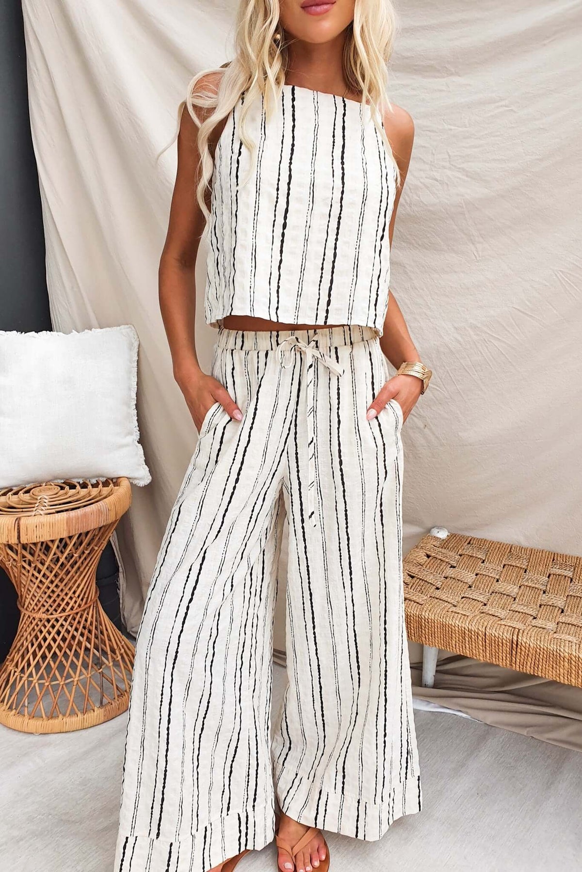 Woman wearing Frances Pants, lightweight linen with elastic waistband and pockets, styled with a matching crop top.