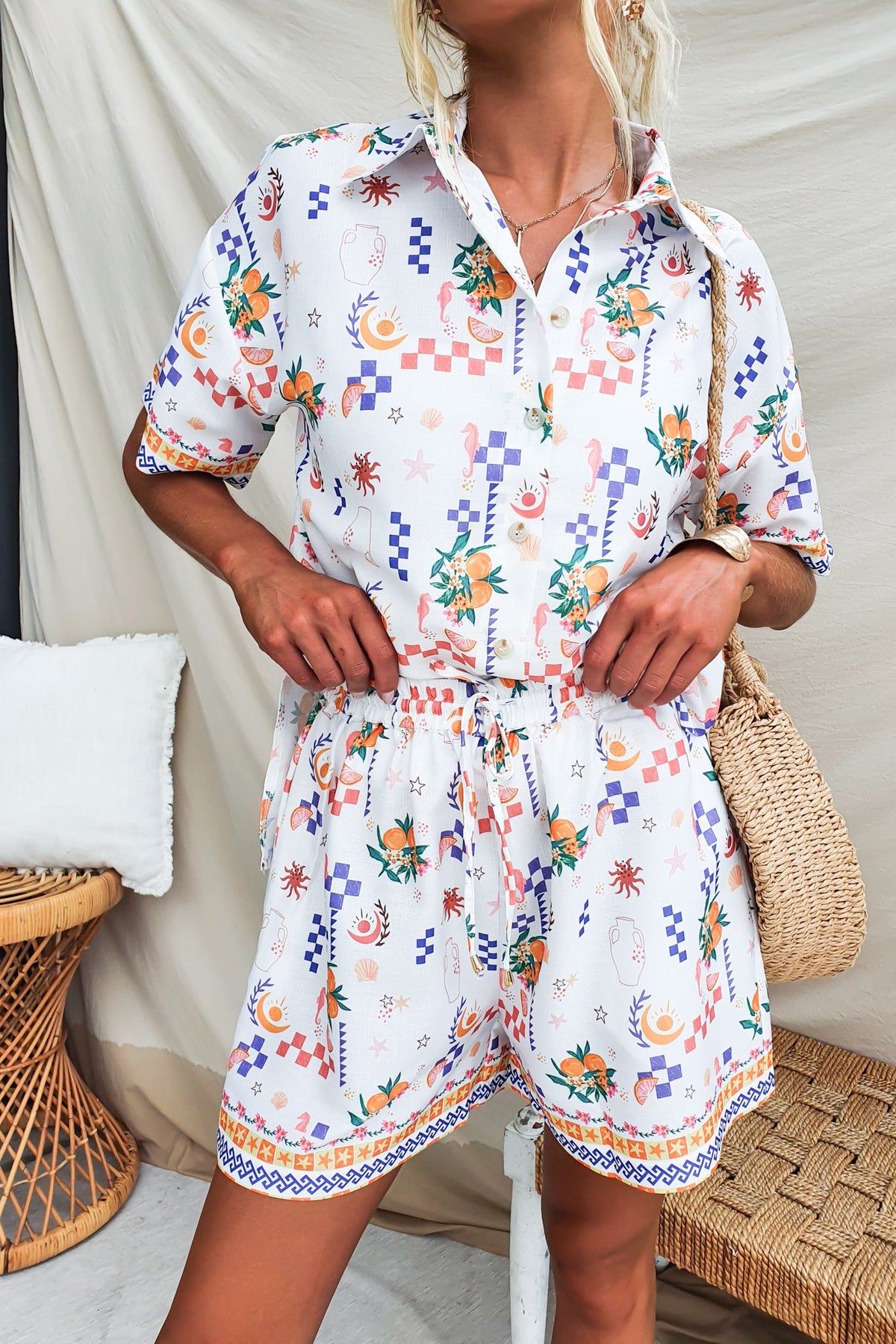 Abstract print shorts with a mid-high waist, elastic waistband, and pockets styled with floral details.