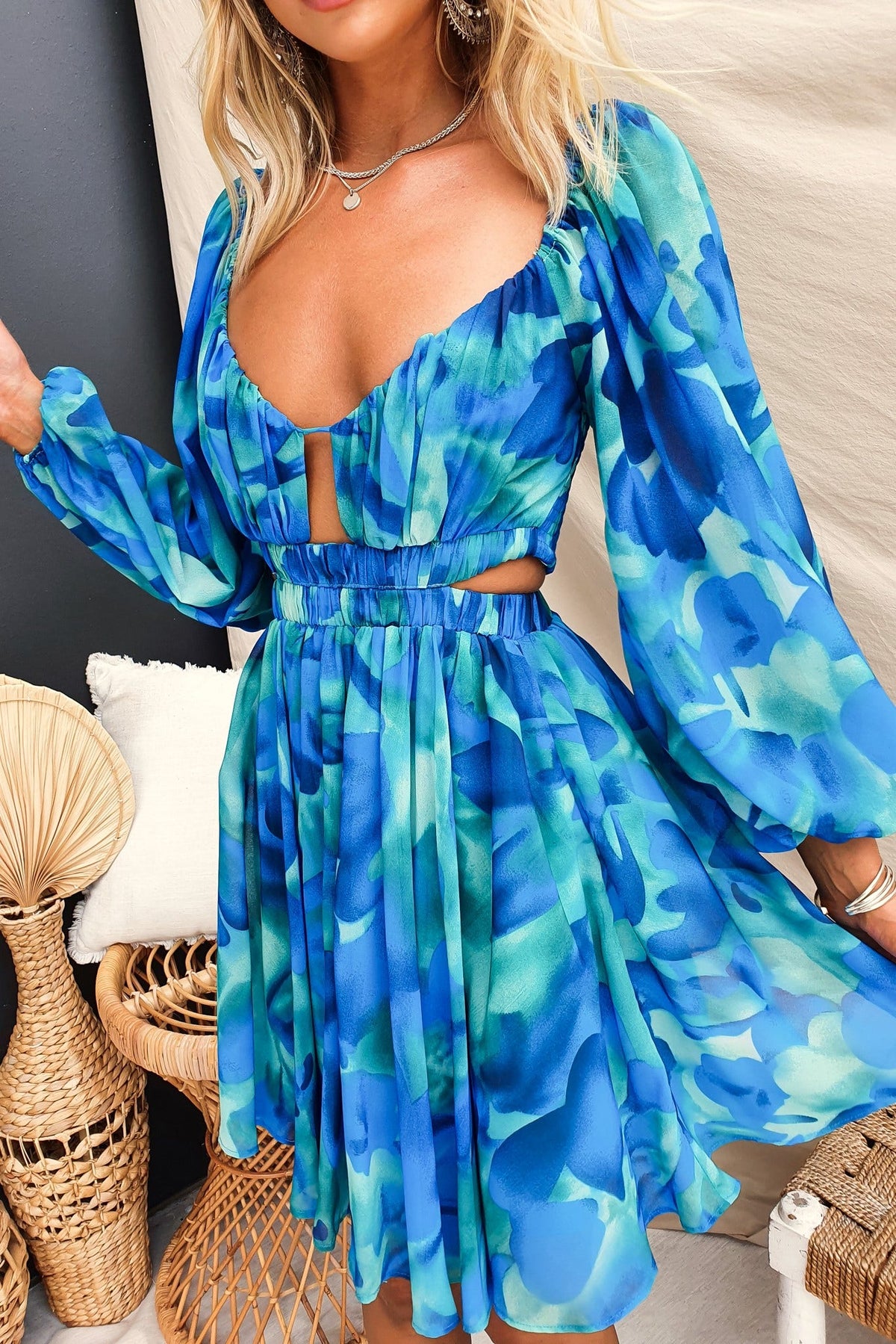 Ellia Dress in blue chiffon with cut-outs, elastic sleeves, and waistband, showcasing a stylish summer look.
