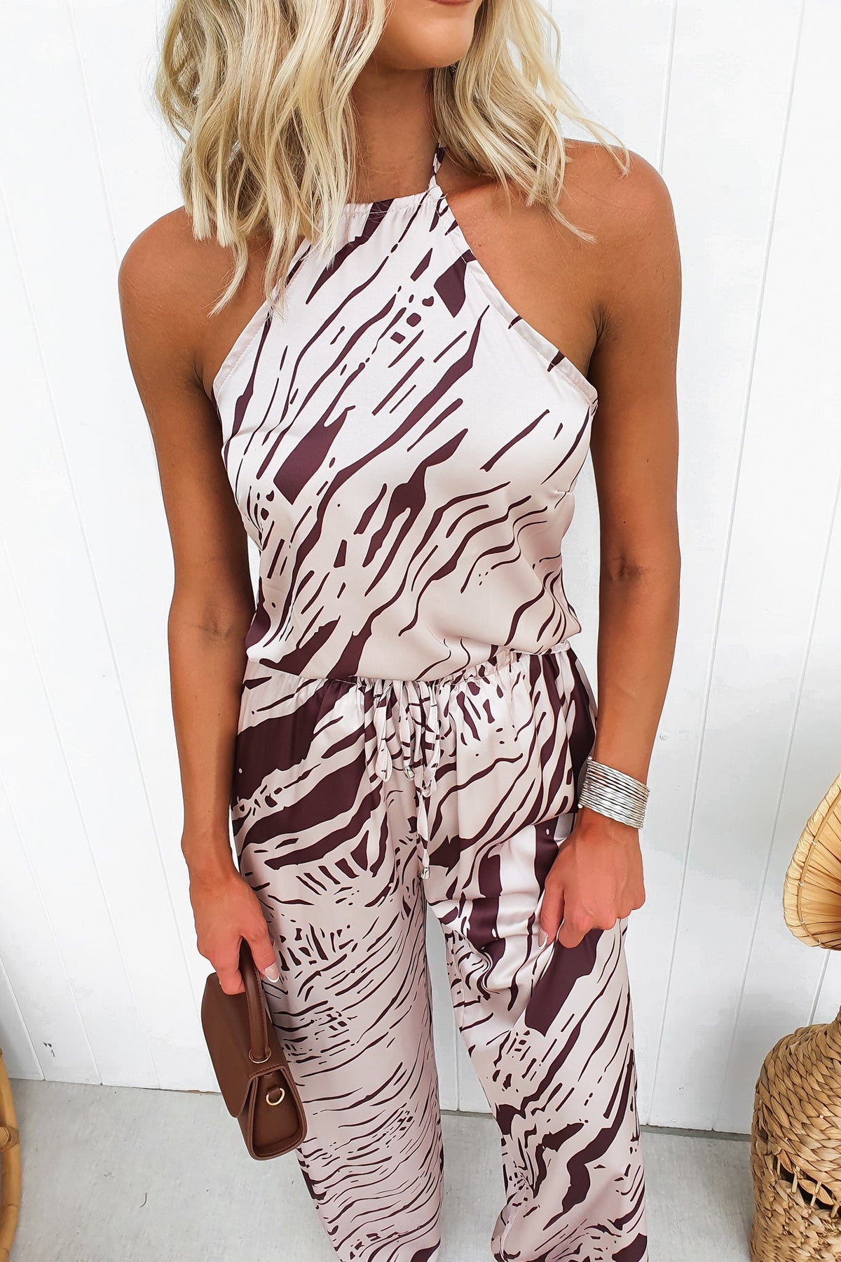 Model wearing Up All Night top with abstract print, adjustable halter neckline, and satin look in neutral tones.