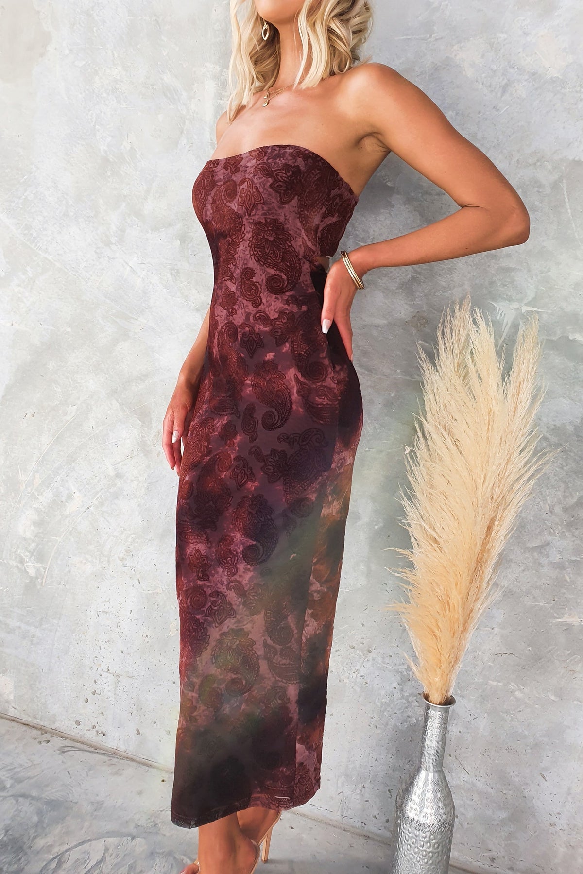 Karmic Midi Dress in burgundy with strapless design and velvet embossed print, featured on a model.