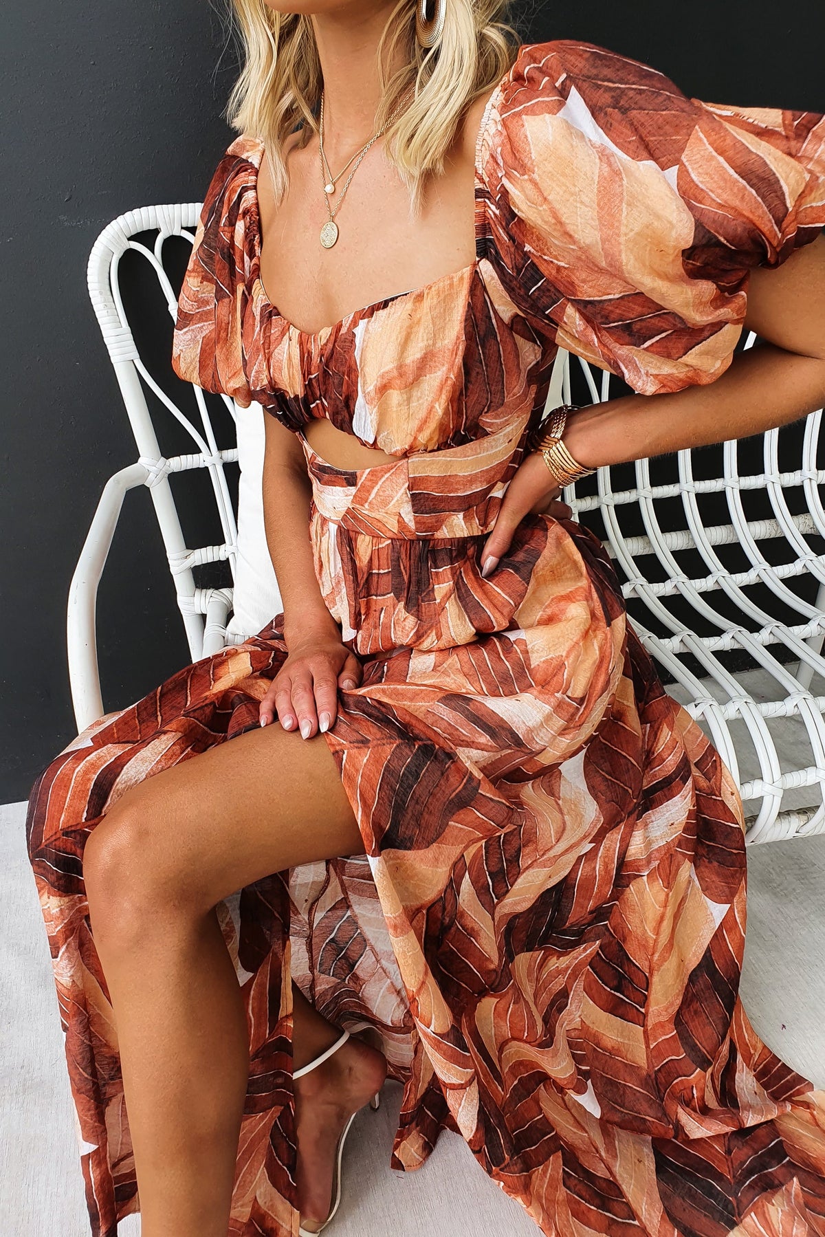 Damaris Maxi Dress featuring a stylish cut-out under the bust and flowing chiffon fabric in warm tones.