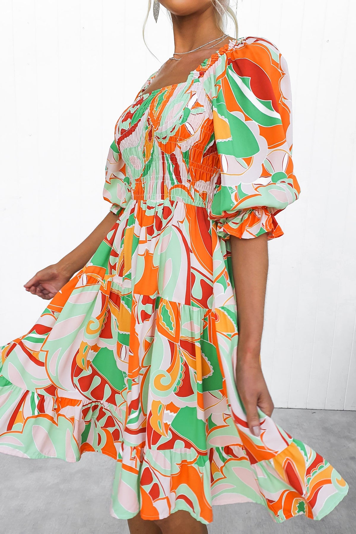 Colorful Tremmy Dress featuring an elastic bodice and puff sleeves, perfect for stylish summer outings.