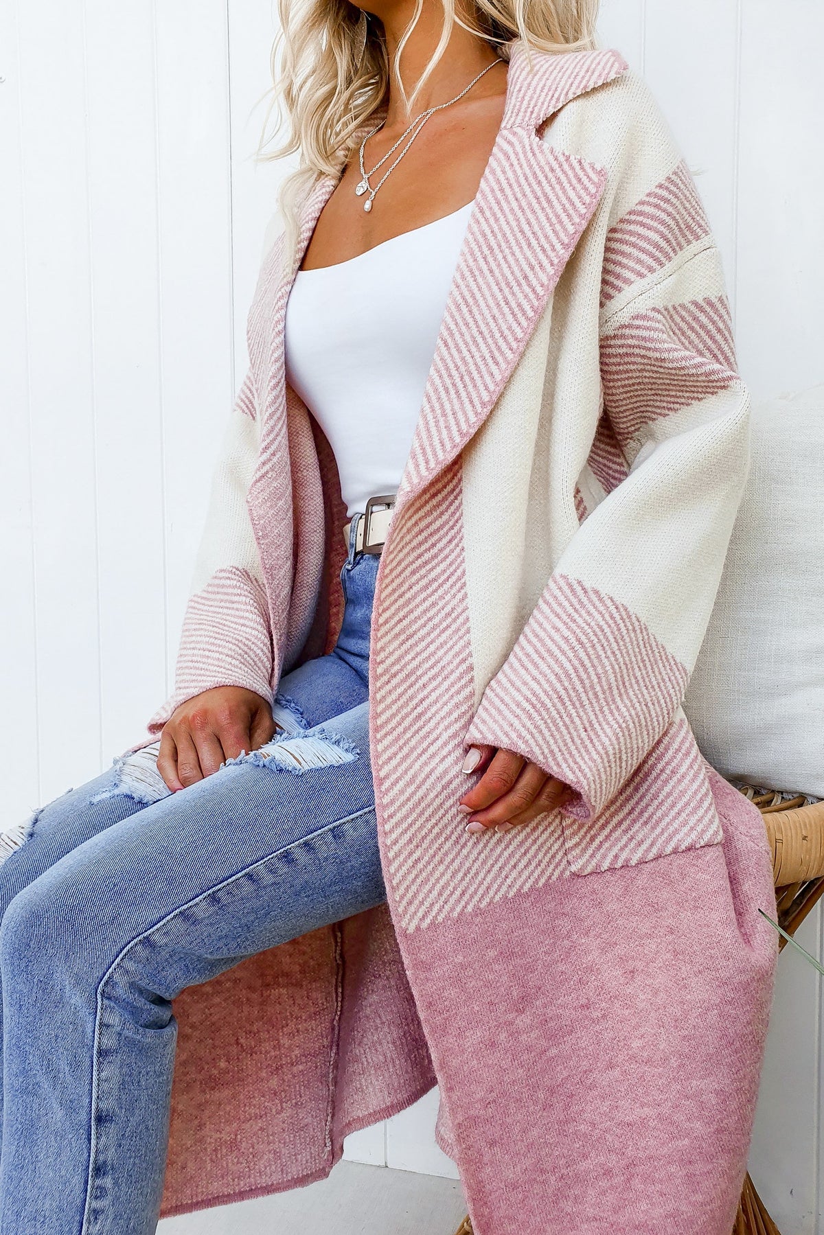 Kellan Cardigan featuring a longline fit with collar, lapel, and pockets in striped knit design, worn with denim jeans.