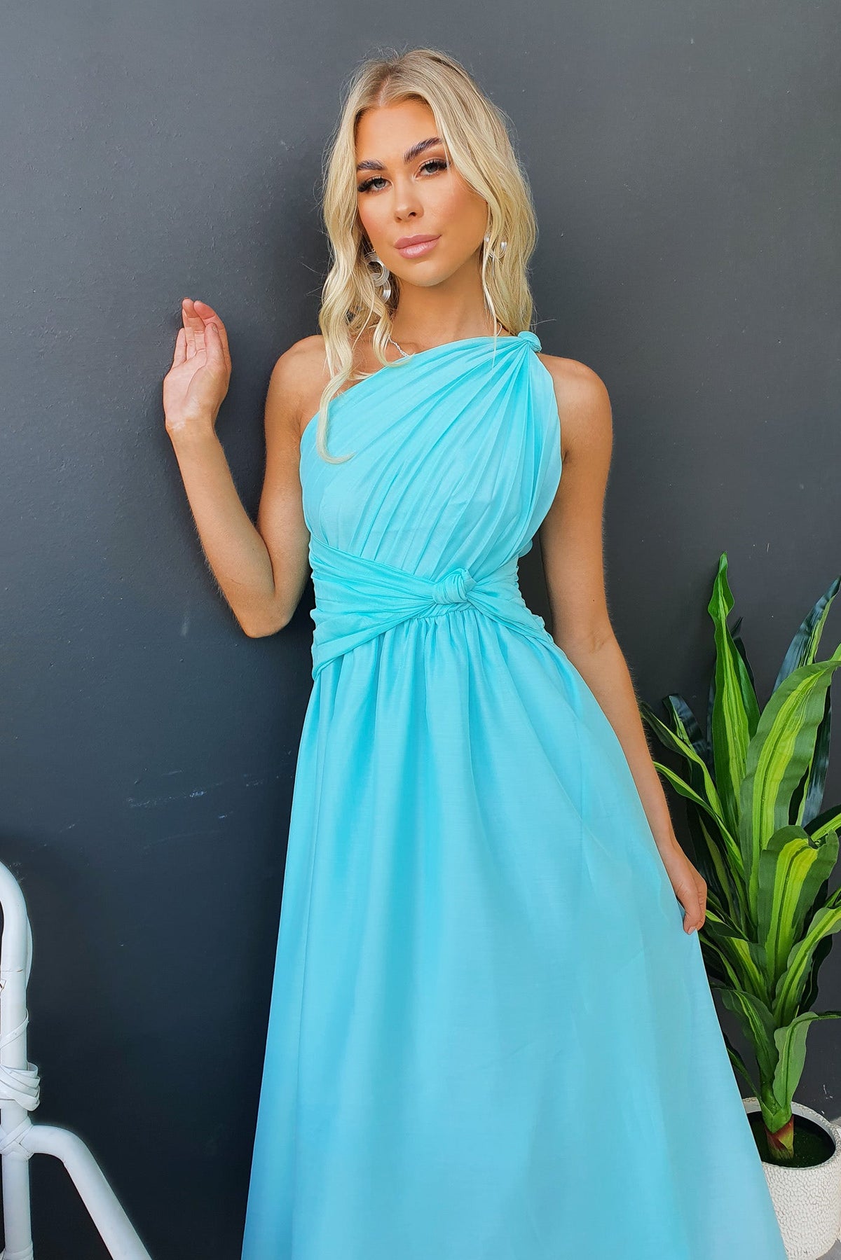 Arturo Midi Dress in light blue, featuring one-shoulder neckline and front knot design, perfect for elegant occasions.