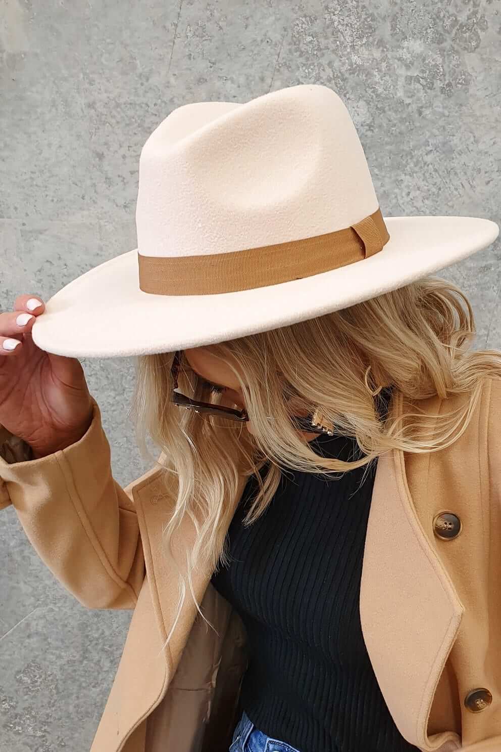 Stylish Austin hat with ribbon trim, perfect for casual and chic outfits, model wears it elegantly.