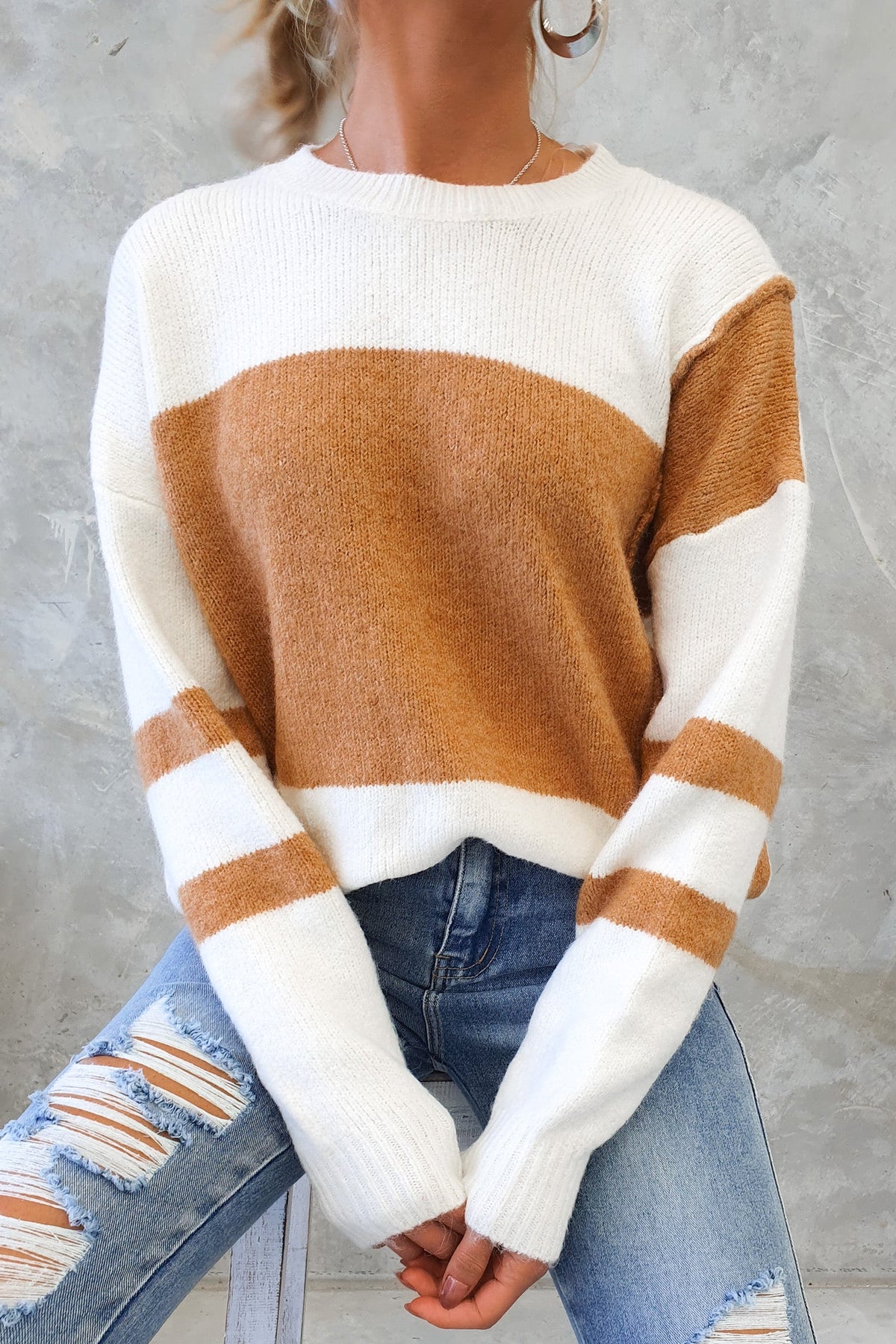 Wezen Jumper featuring a round neckline, knit material, and a relaxed fit in cream and caramel stripes.