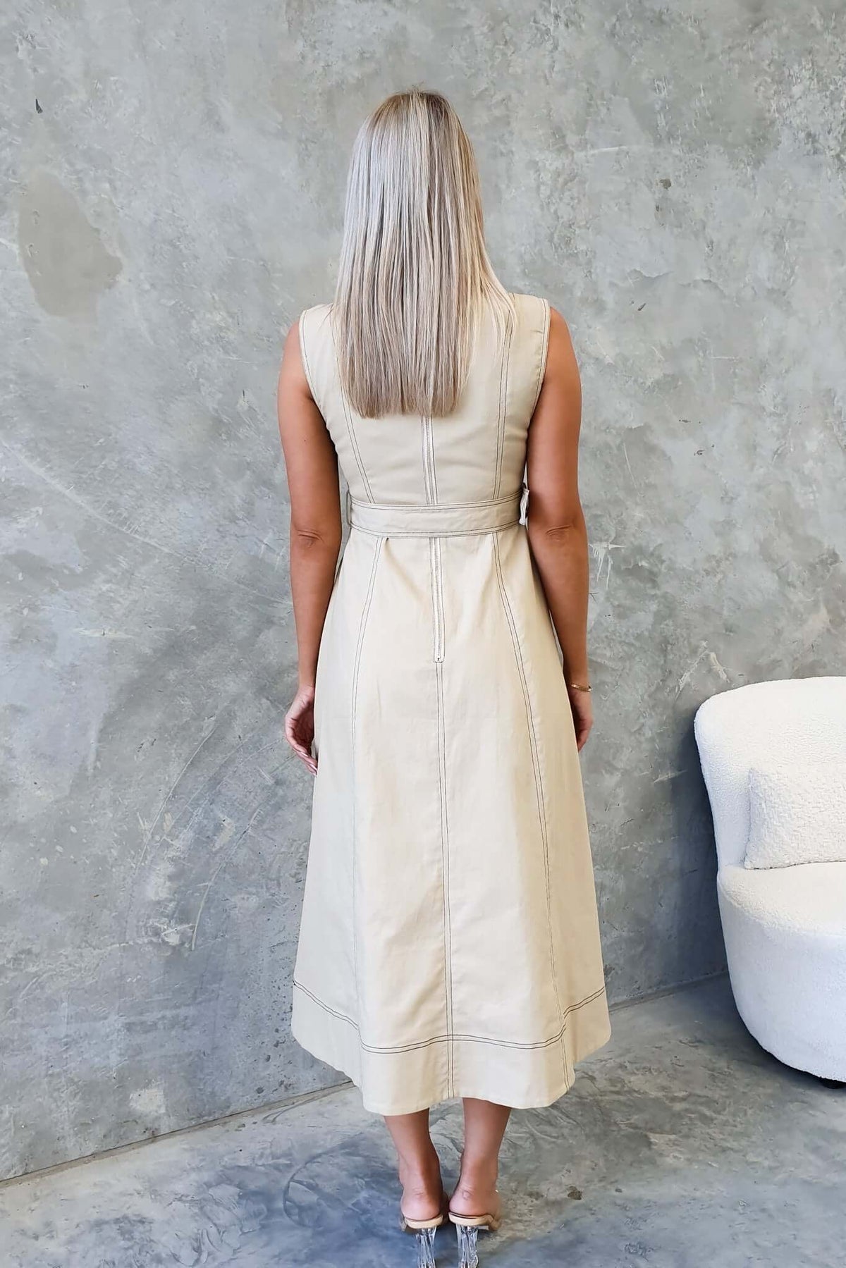 Back view of a woman wearing a Ravil Denim Midi Dress, featuring a fitted design and removable belt.