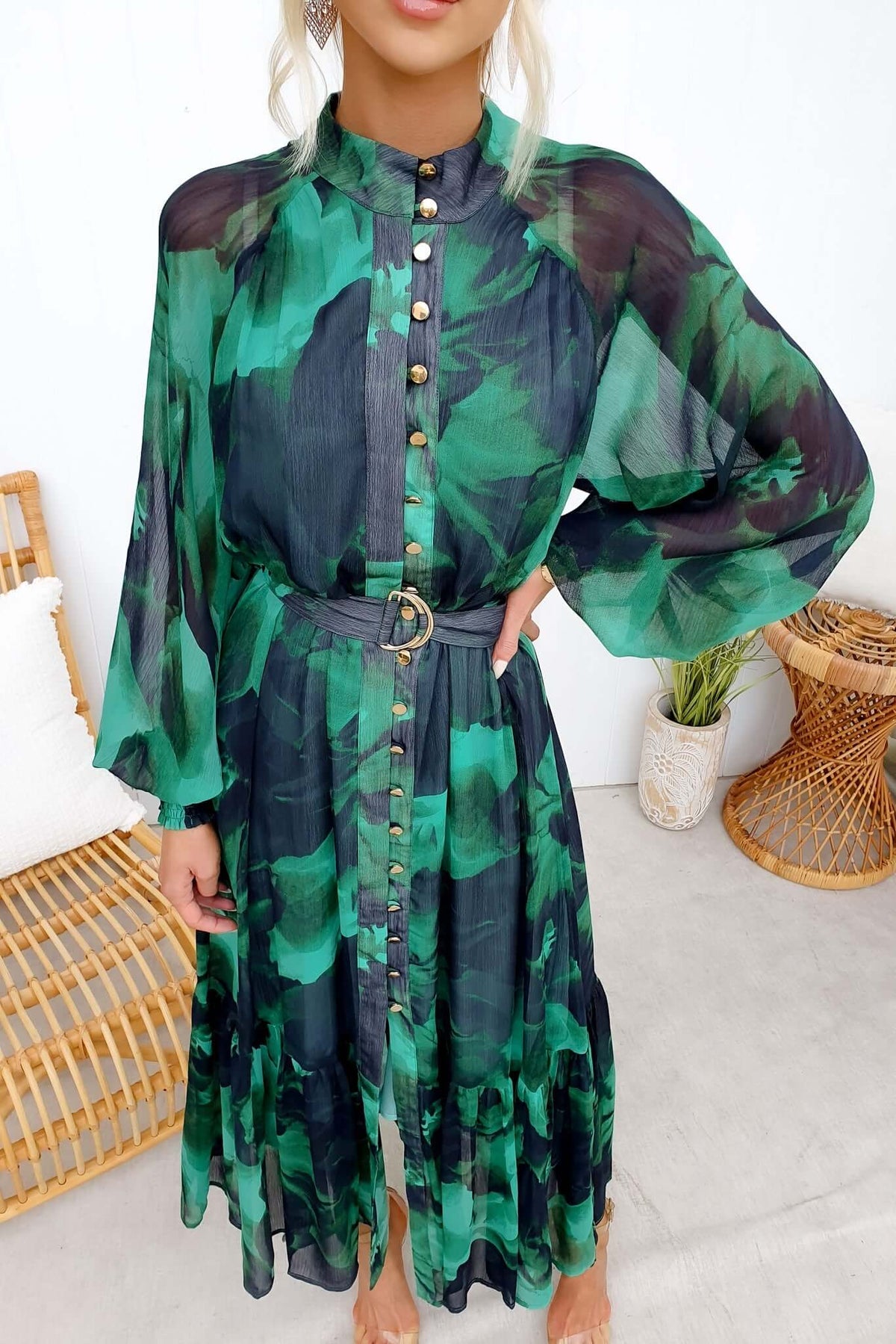 Woman wearing Orazio Maxi Dress in green floral chiffon with button-up front and removable belt.