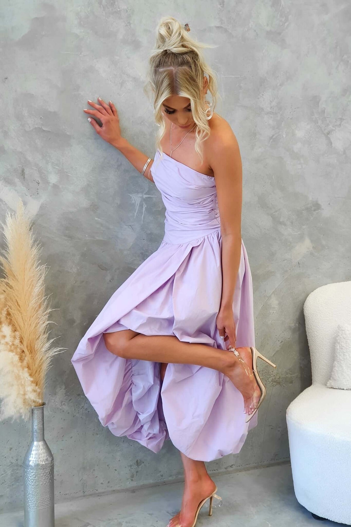 Elegant Carette Midi Dress in soft lavender, featuring an asymmetric hemline and stylish strapless design.