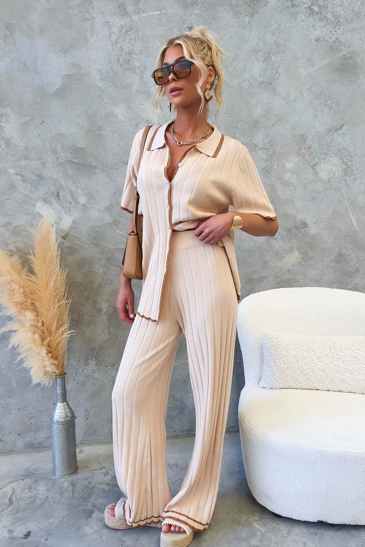Jodie Pants in a stylish mid-high waist ribbed knit, worn with a matching top and sunglasses, perfect for casual chic looks.