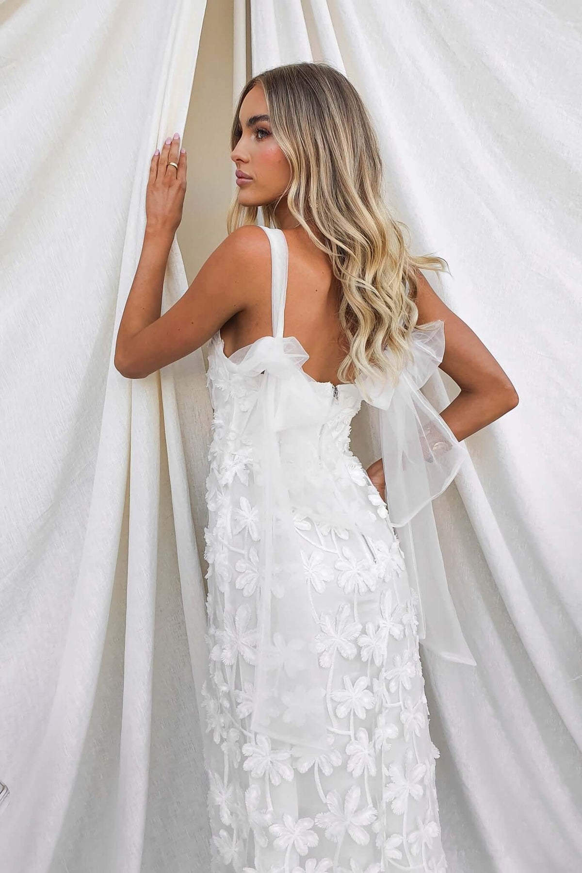 Xaria Maxi Dress featuring tie straps and tulle embroidery, displayed against a soft white backdrop.