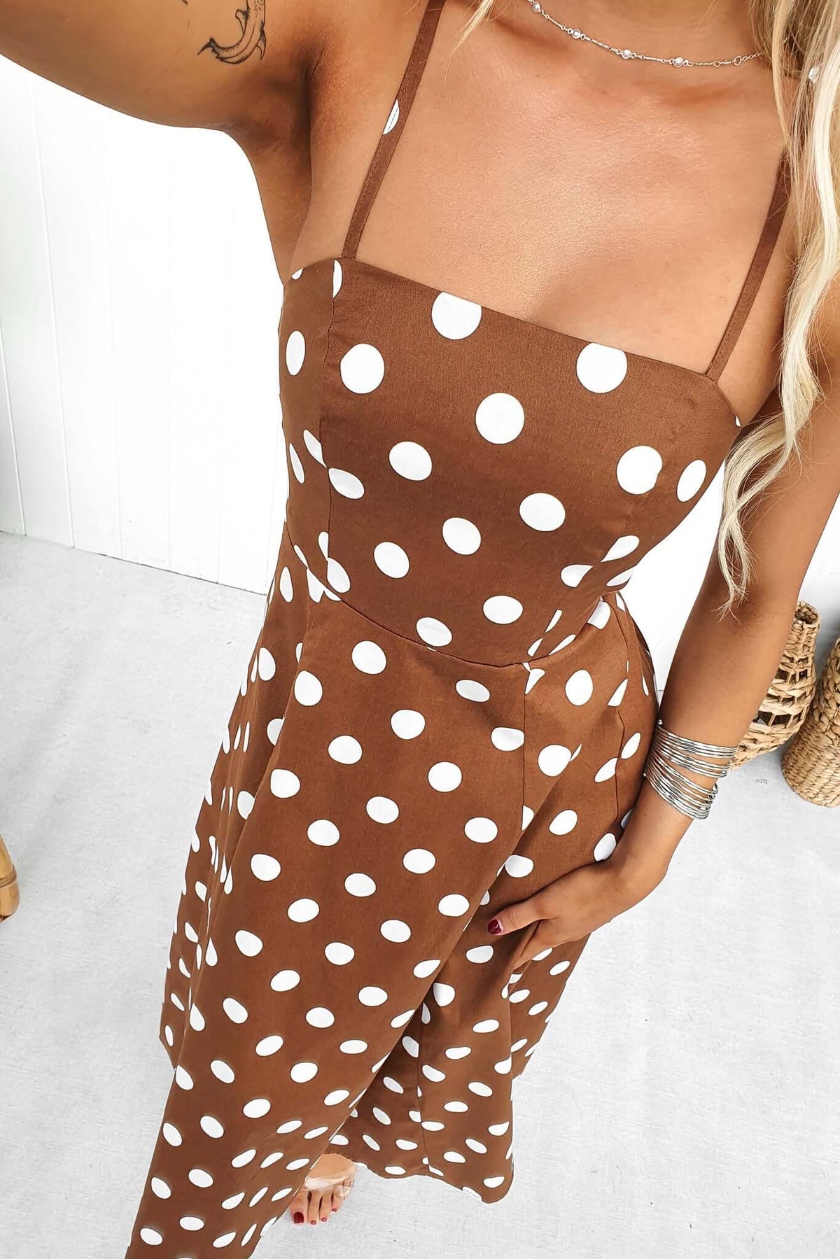 Brown polka dot midi dress with adjustable straps and square neckline, perfect for casual or semi-formal occasions.