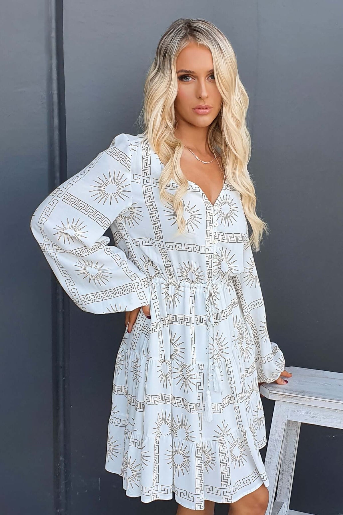 Sun is Out Dress with button-down front, elastic waist, and pockets in lightweight cotton fabric, styled by a model.