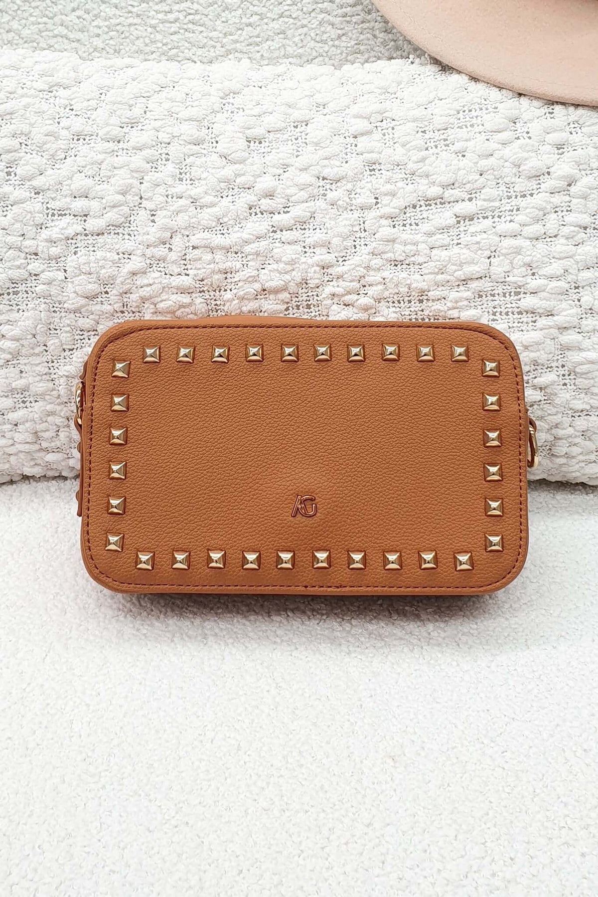 Veronica Crossbody Bag in tan leather with metallic studs, stylish and compact for any occasion.