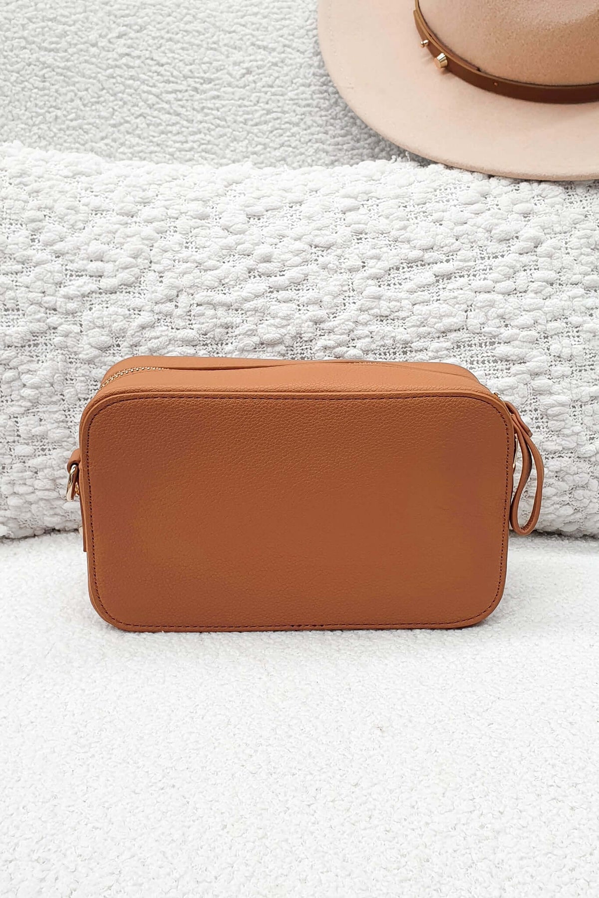 Veronica Crossbody Bag in tan faux leather, perfect size for essentials, showcased on a textured white background.