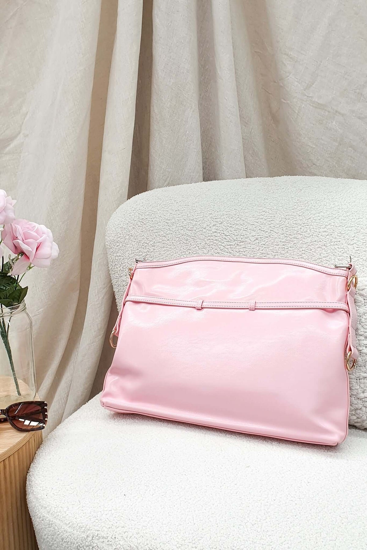 Stylish pink Bily Bag displayed on a cozy chair, perfect for everyday essentials and elevating your tote collection.