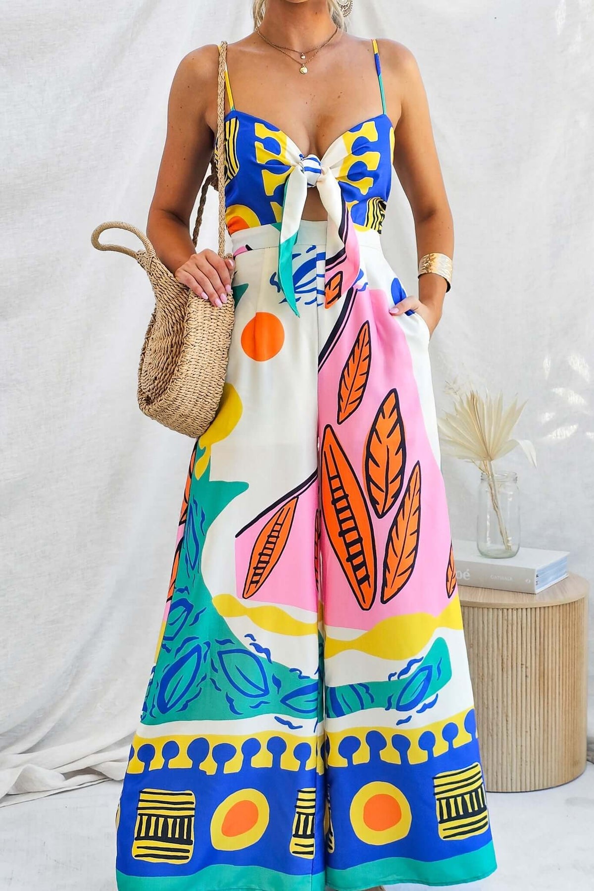 Colorful Sun Dazed jumpsuit with adjustable straps and tie at bust, perfect for summer outings.