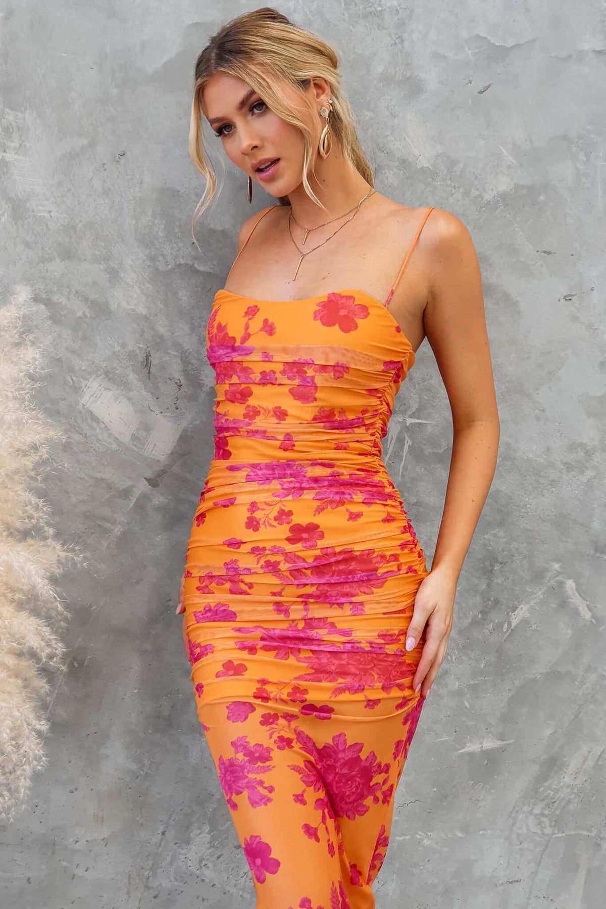 Model wearing Azriel Midi Dress, featuring a ruched mesh overlay, adjustable straps, and floral pattern.