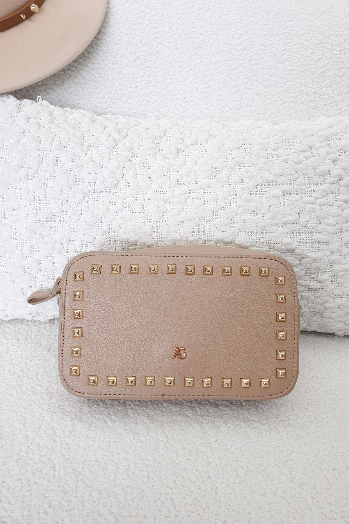 Veronica Crossbody Bag in beige with metallic studs, stylish and compact for essentials, perfect for outings.