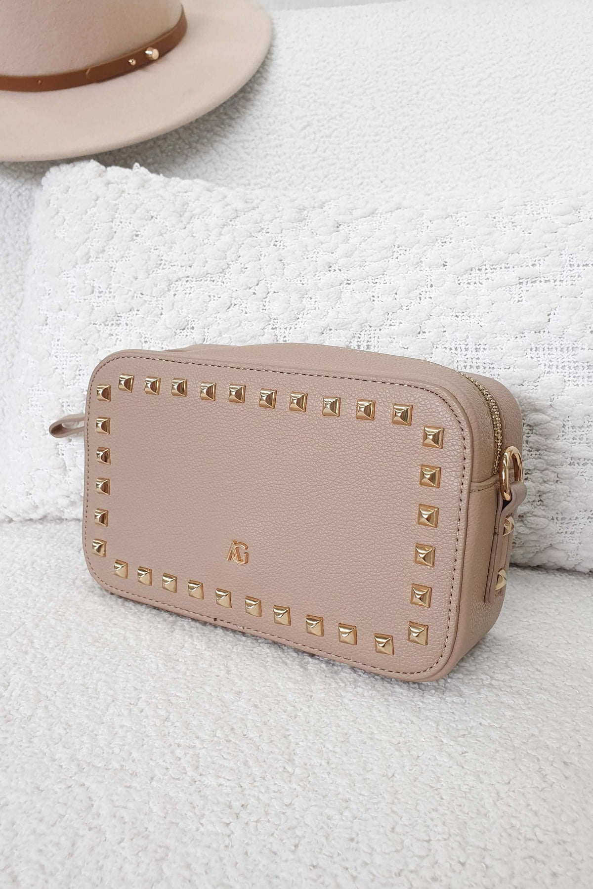 Veronica Crossbody Bag in beige with metallic studs, perfect for essentials and stylish for the dancefloor.