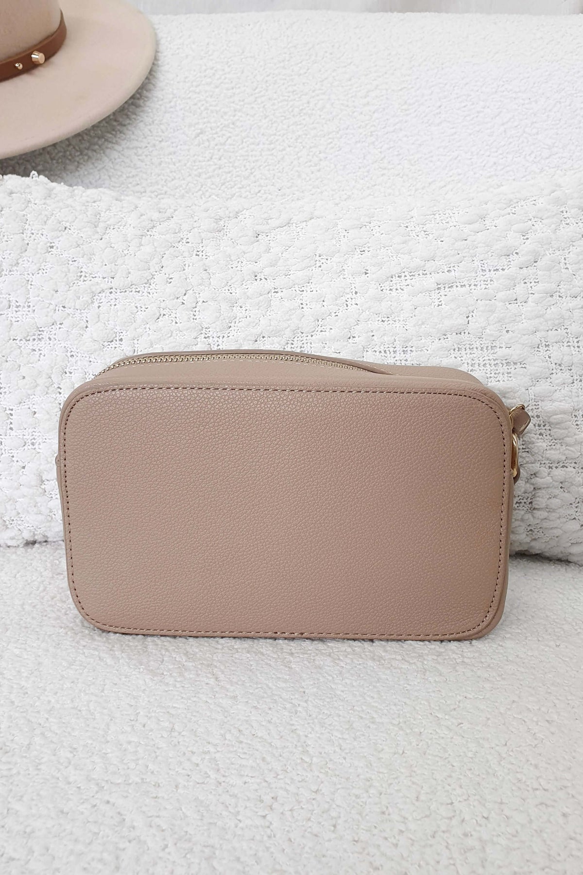 Beige compact zip pouch on textured surface, ideal for organizing essentials and suitable for any occasion.