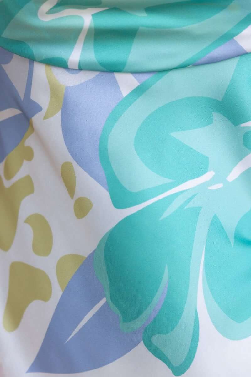 Floral print detail in shades of blue and green on satin fabric of Brighton Midi Dress, showcasing its elegant design.