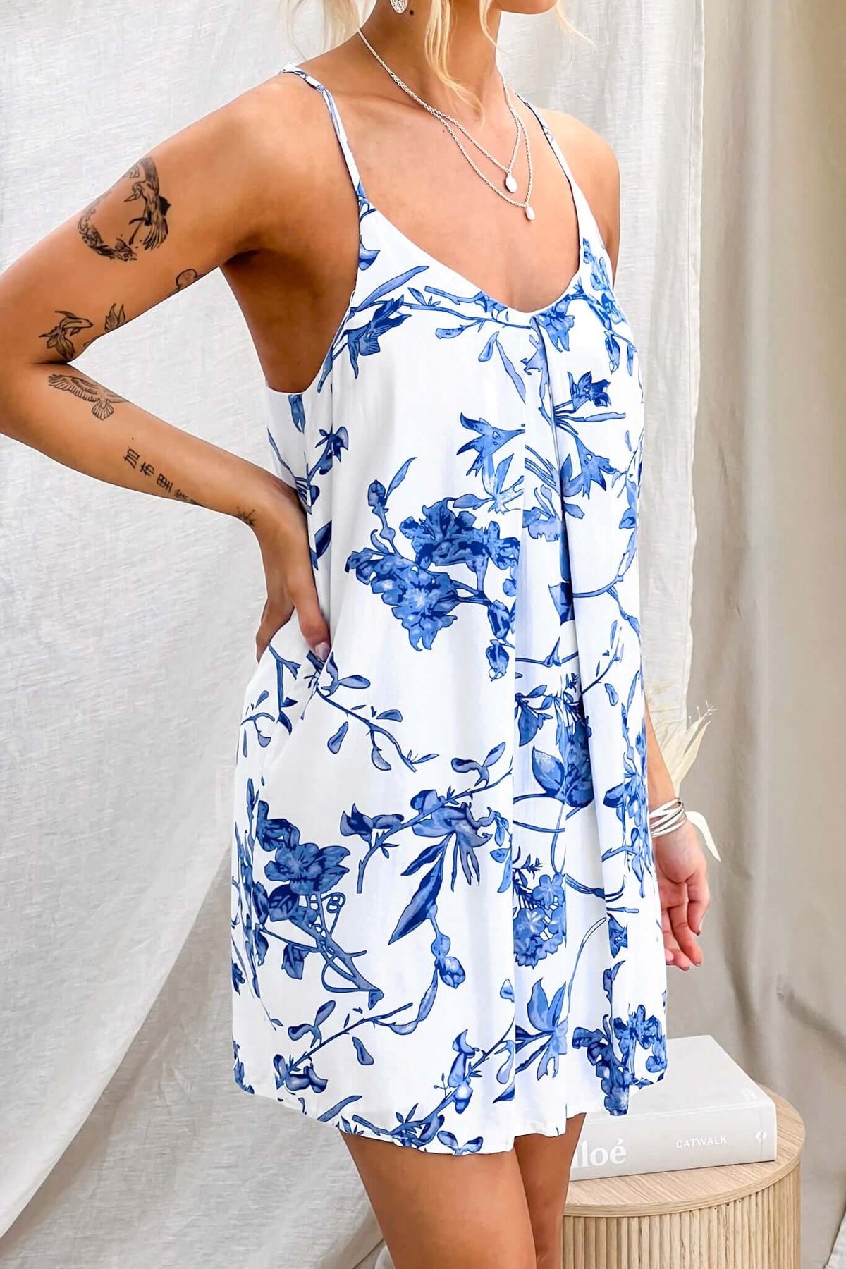 Laure Dress featuring adjustable straps and floral pattern, perfect for a relaxed summer look.