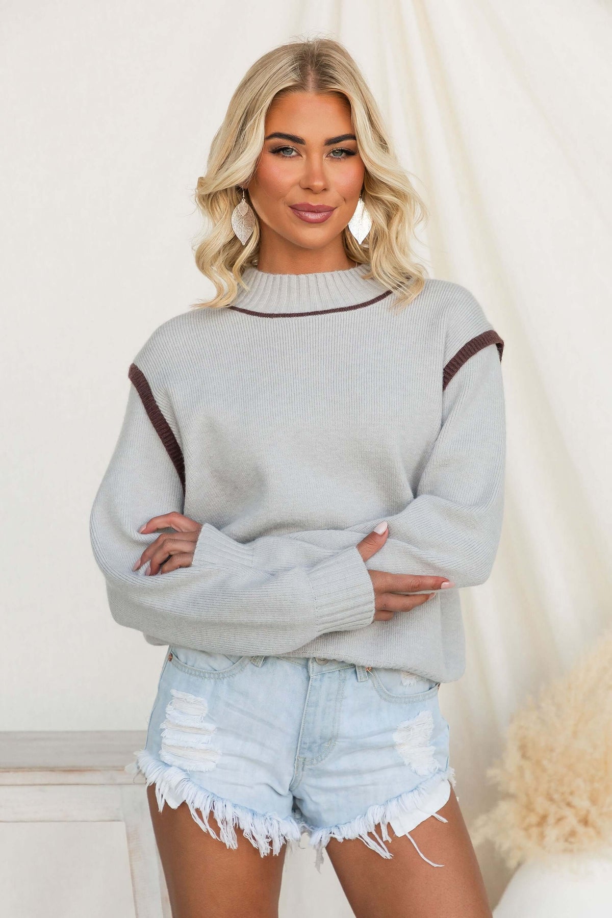 Model wearing the Nights Out Jumper, a cozy knit top with a mock neckline and relaxed fit.