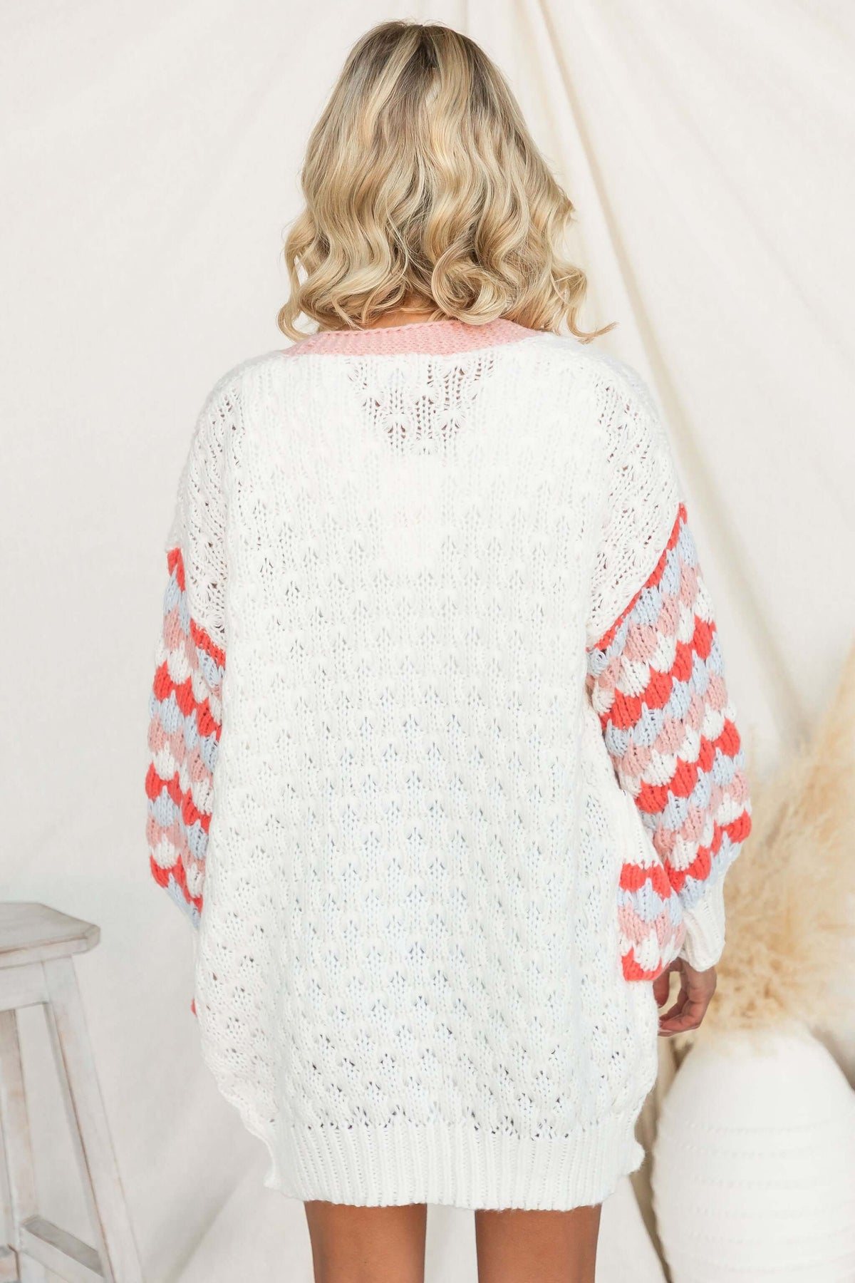 Back view of a longline Wild Romance Cardigan featuring colorful knit sleeves and a relaxed fit.