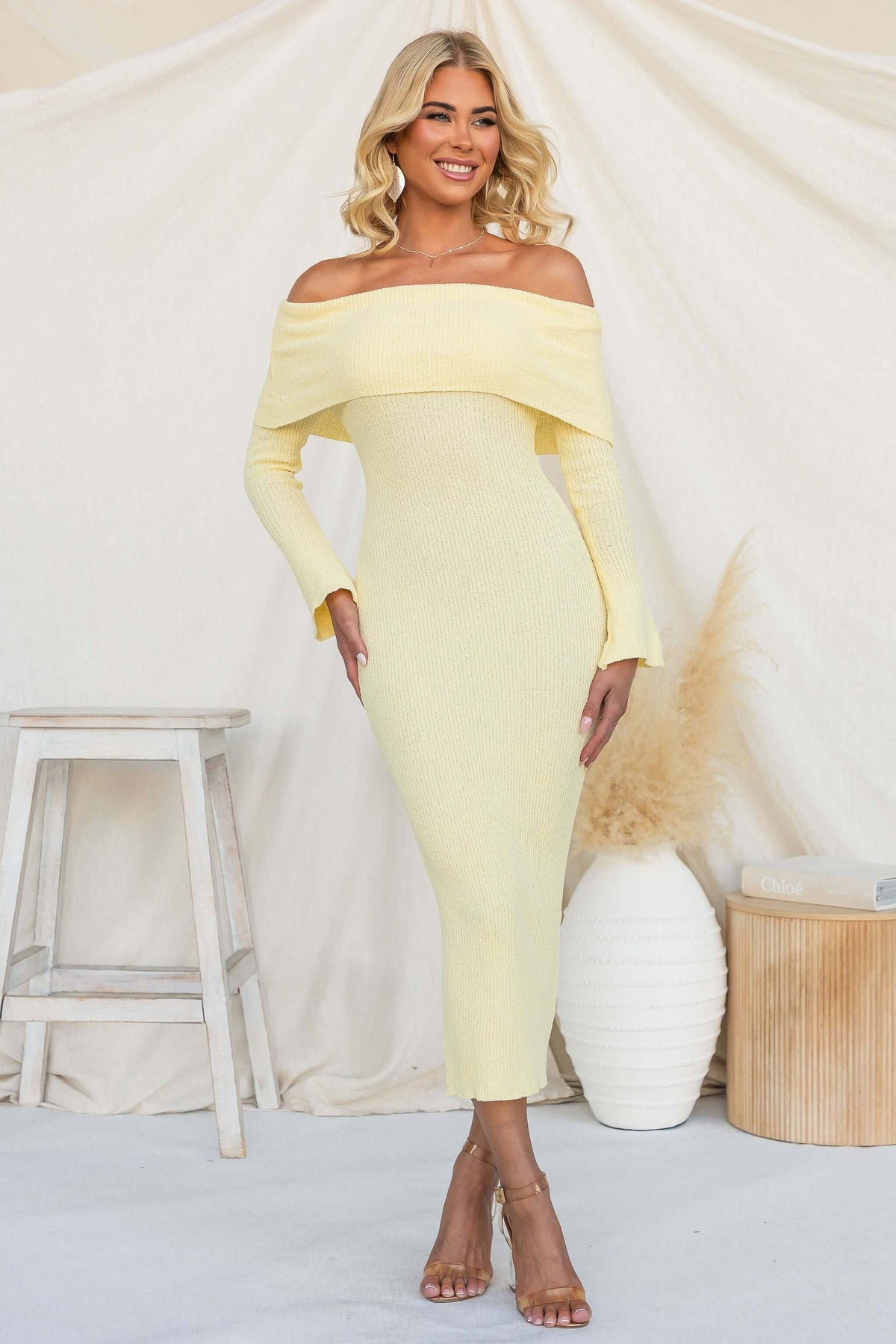 Breeze Midi Dress in off-shoulder style, ribbed knit material, model wearing pastel yellow and posing gracefully.