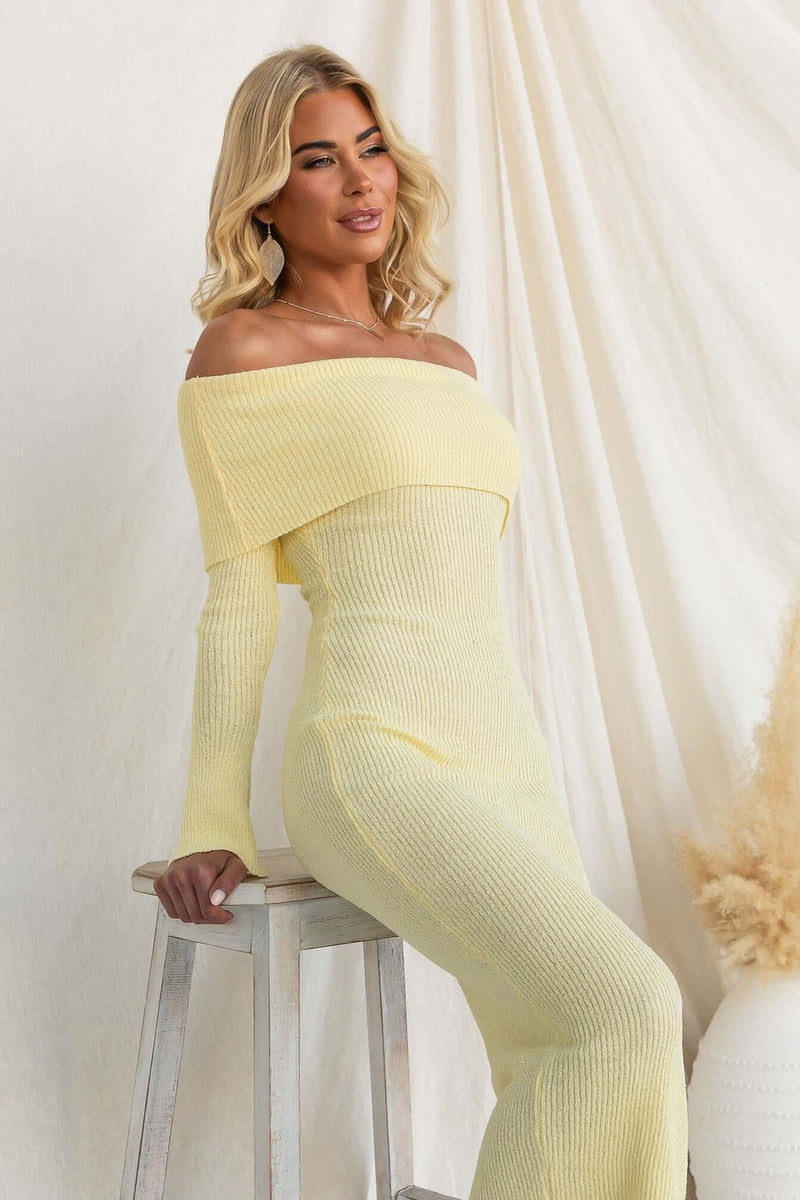 Model wearing the Breeze Midi Dress in yellow, featuring an off-shoulder neckline and ribbed knit material.