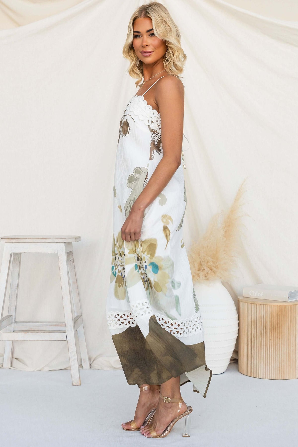 Model wearing Carlo Maxi Dress with floral design and adjustable straps, showcasing a stylish summer look.