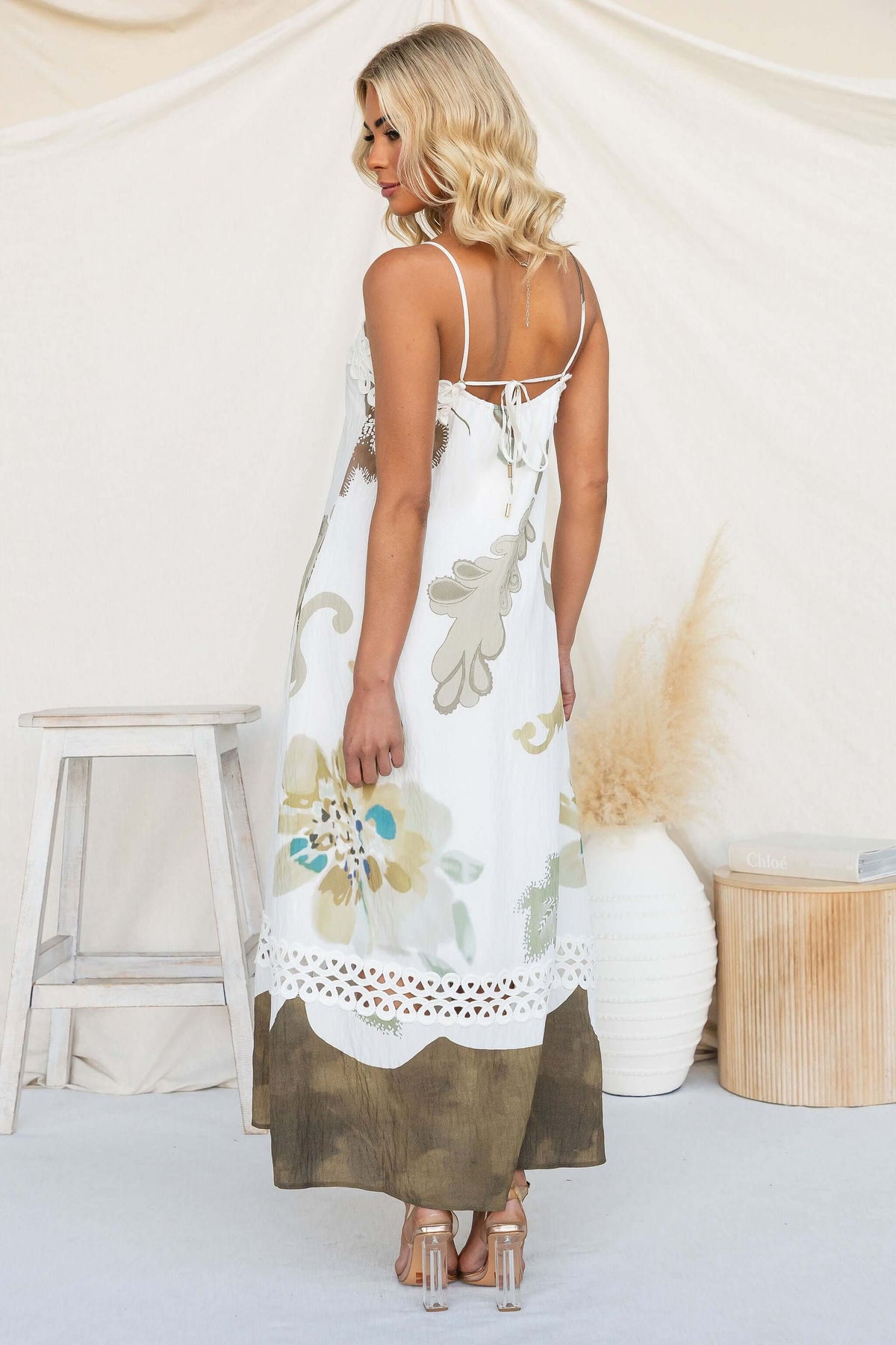 Back view of the Carlo Maxi Dress with floral design and adjustable tie straps.