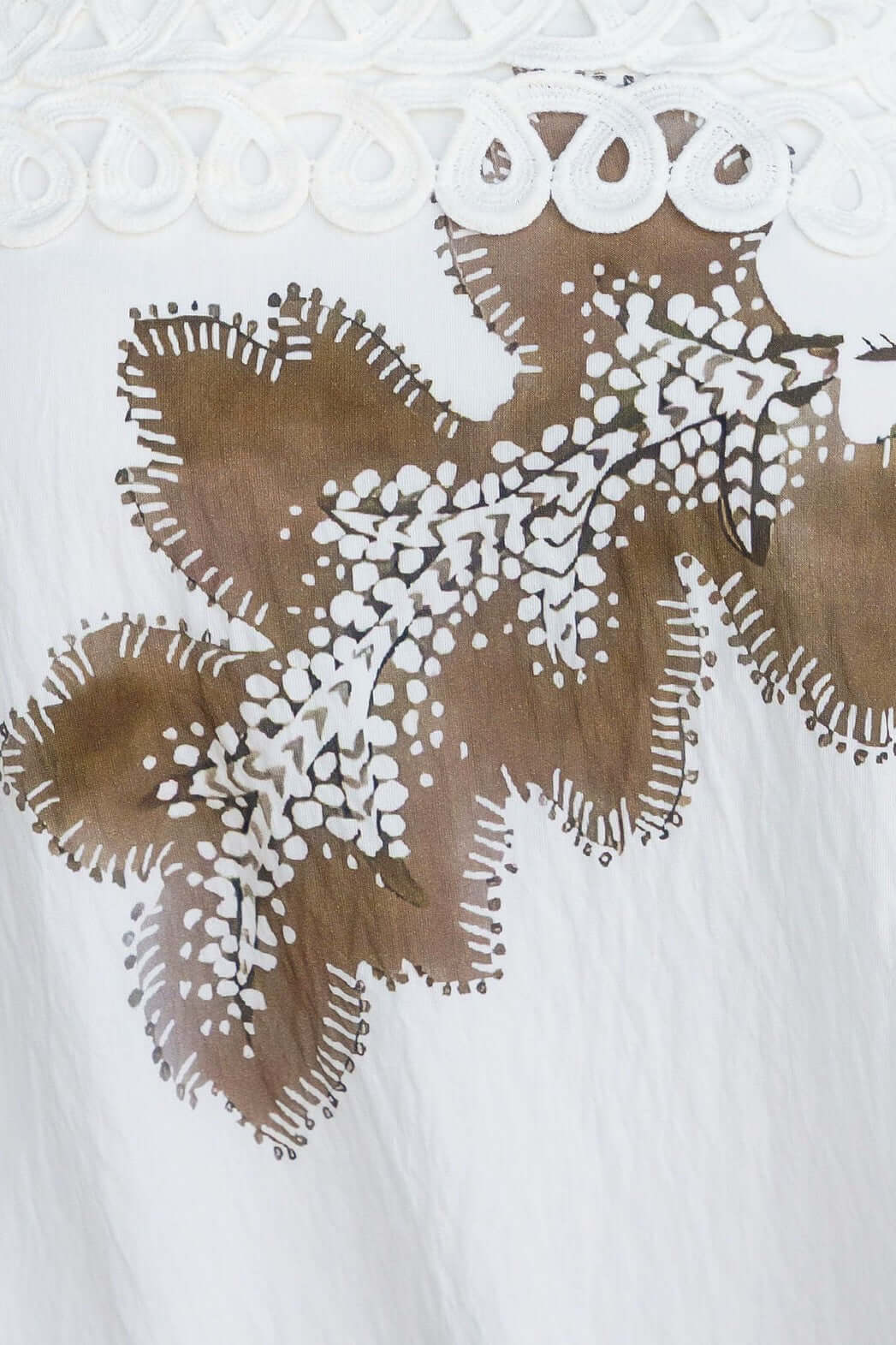 Detail of floral design on Carlo Maxi Dress featuring white background and earthy tones.