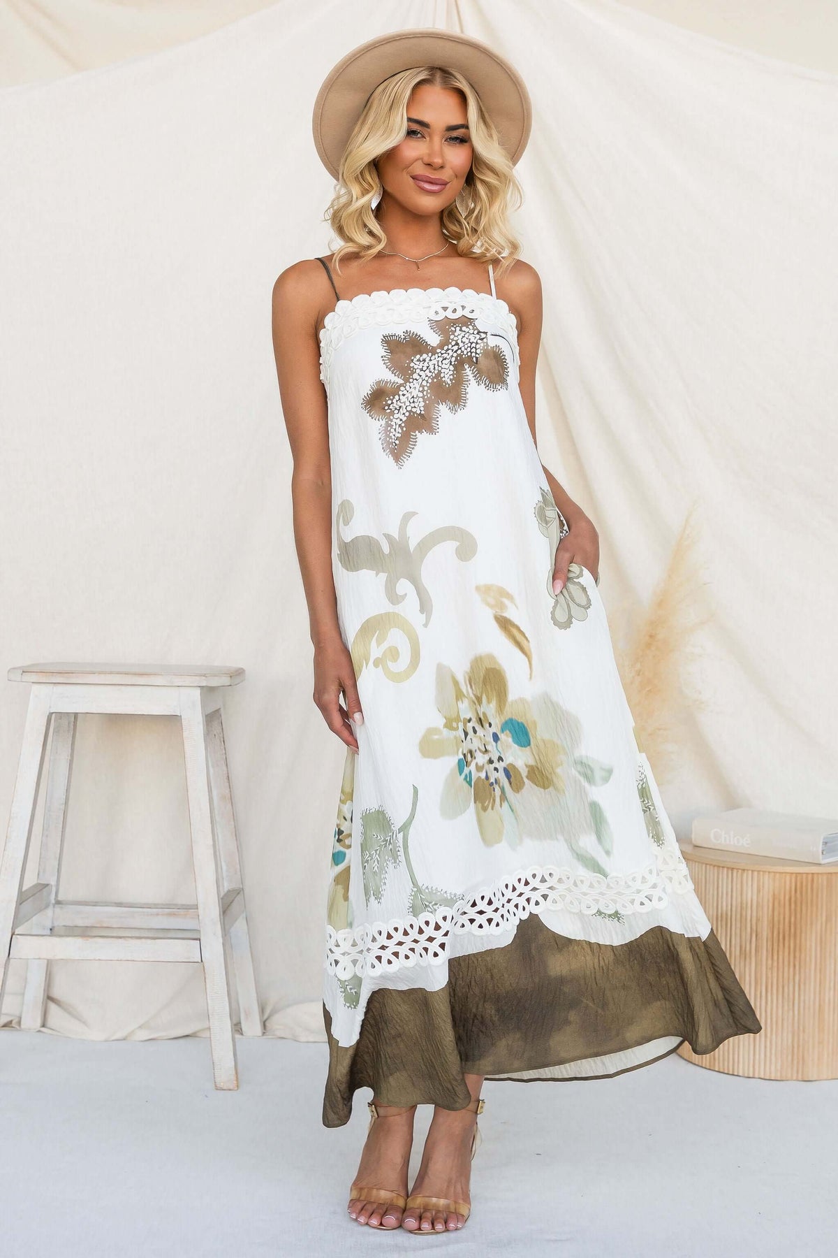 Model wearing the Carlo Maxi Dress with floral patterns, adjustable straps, and a bohemian style.