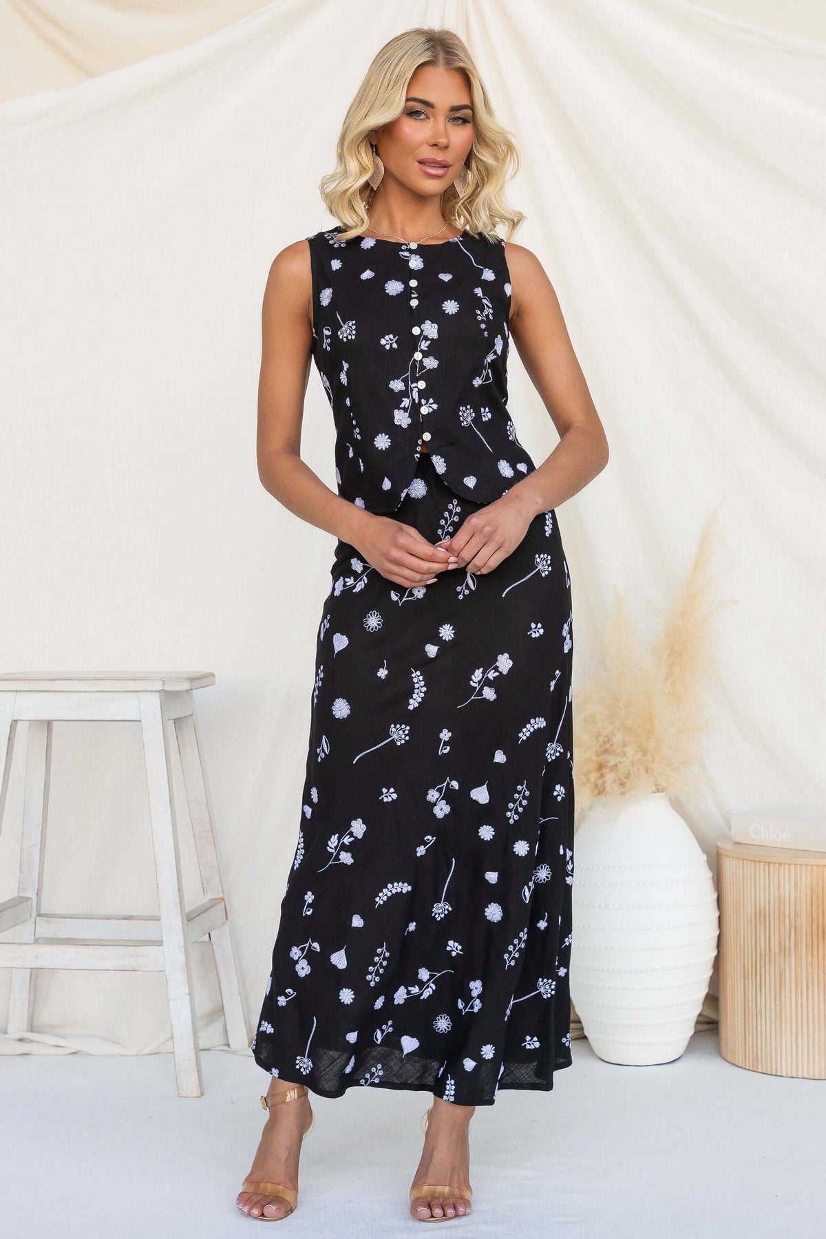 Lune Top featuring a high neckline and button-up front, styled with floral print on a model.