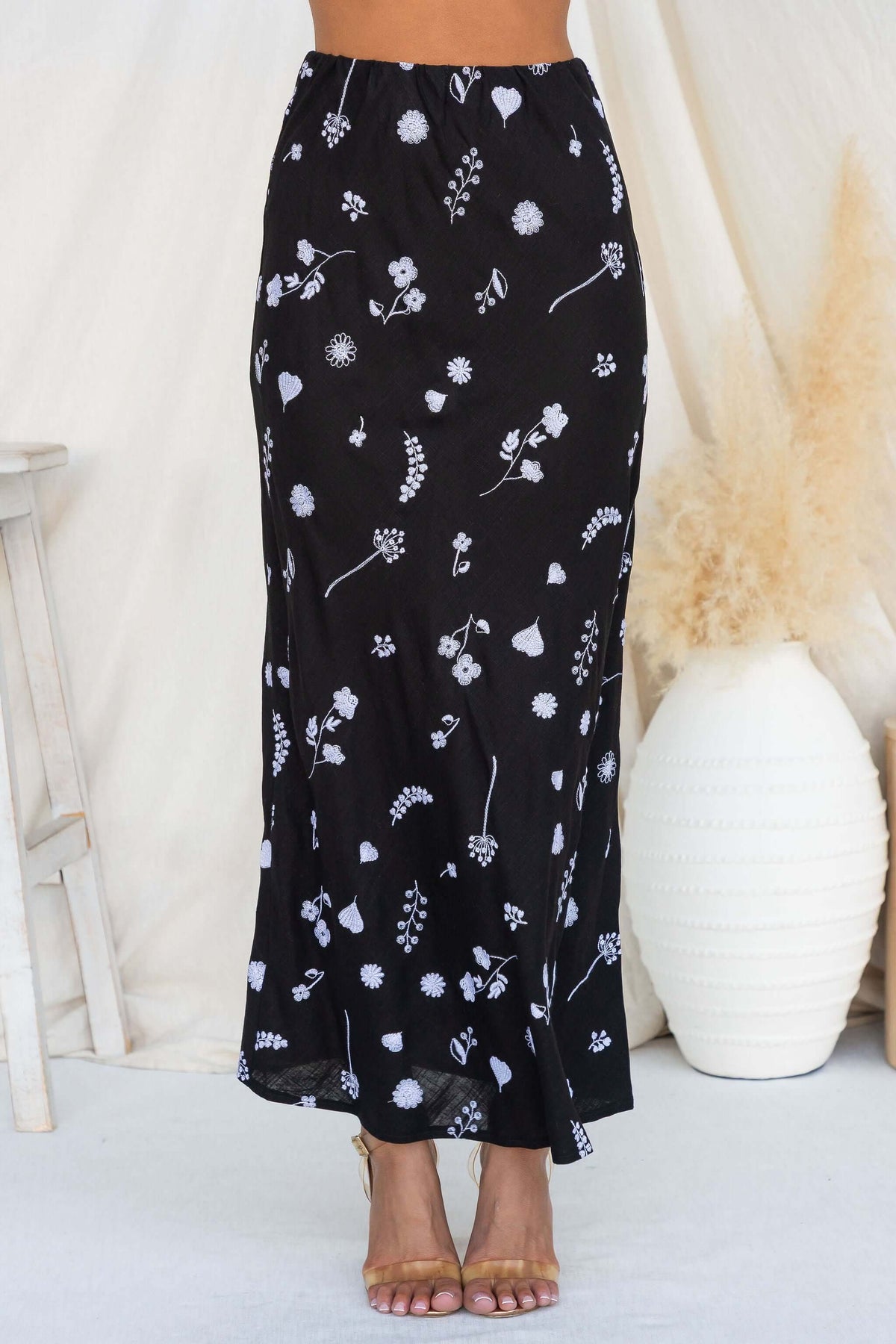 Model wearing the Lune Maxi Skirt featuring a floral pattern and mid-high waist fit.