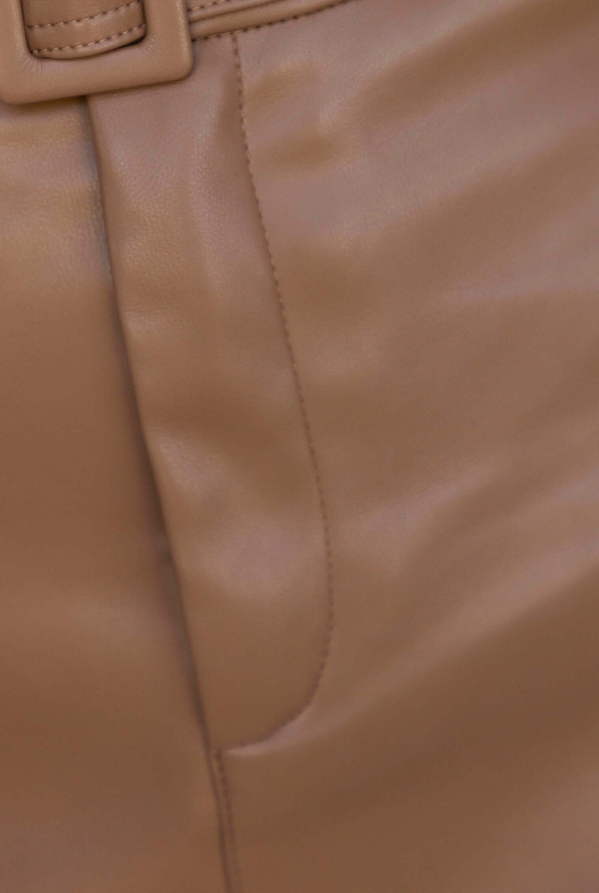 Close-up of the Promise Skirt showing the faux leather texture and removable belt detail.