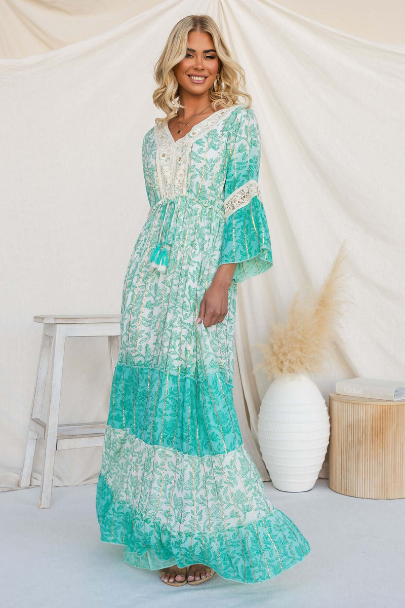 Stylish model in a Mystic Maxi Dress featuring a V-neckline and beautiful prints.