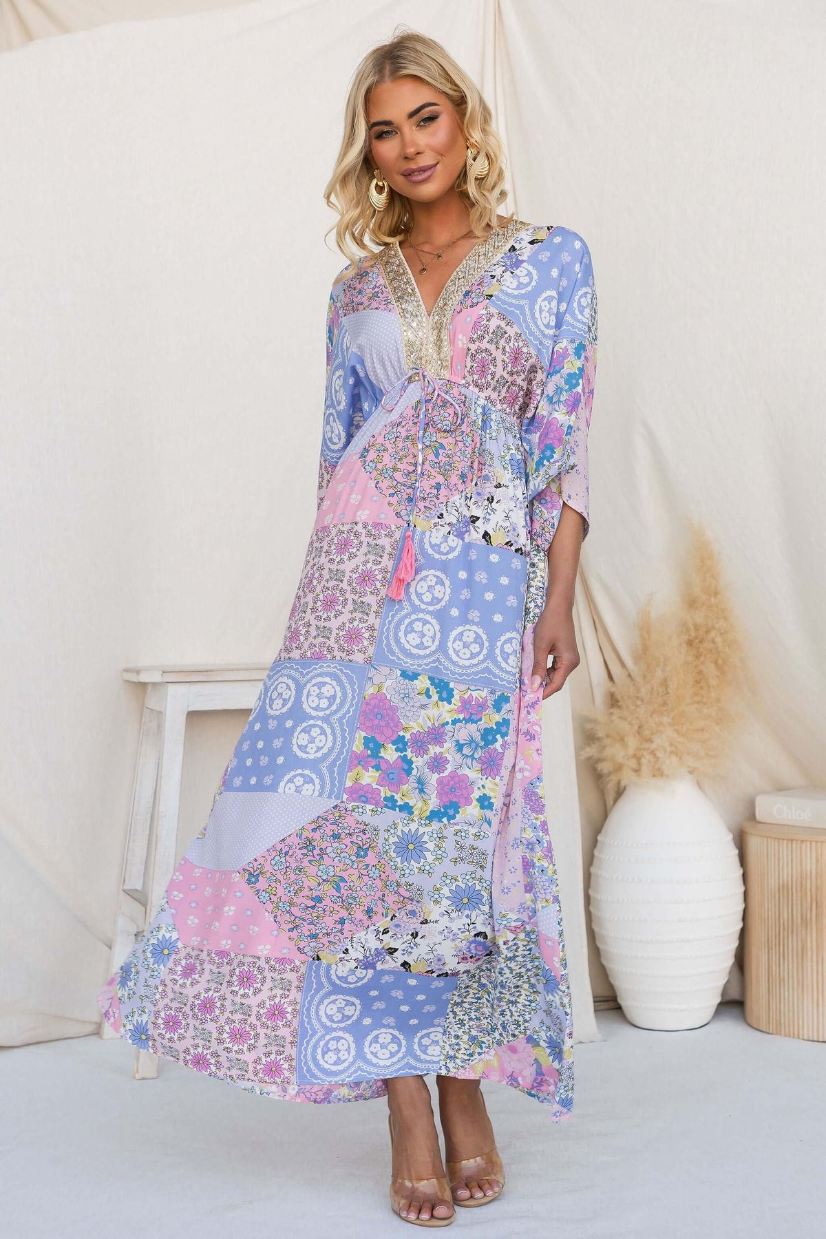 Model wearing Endless Evening Maxi Dress with colorful patchwork design and V-neckline, featuring sleeves and a tie waistband.