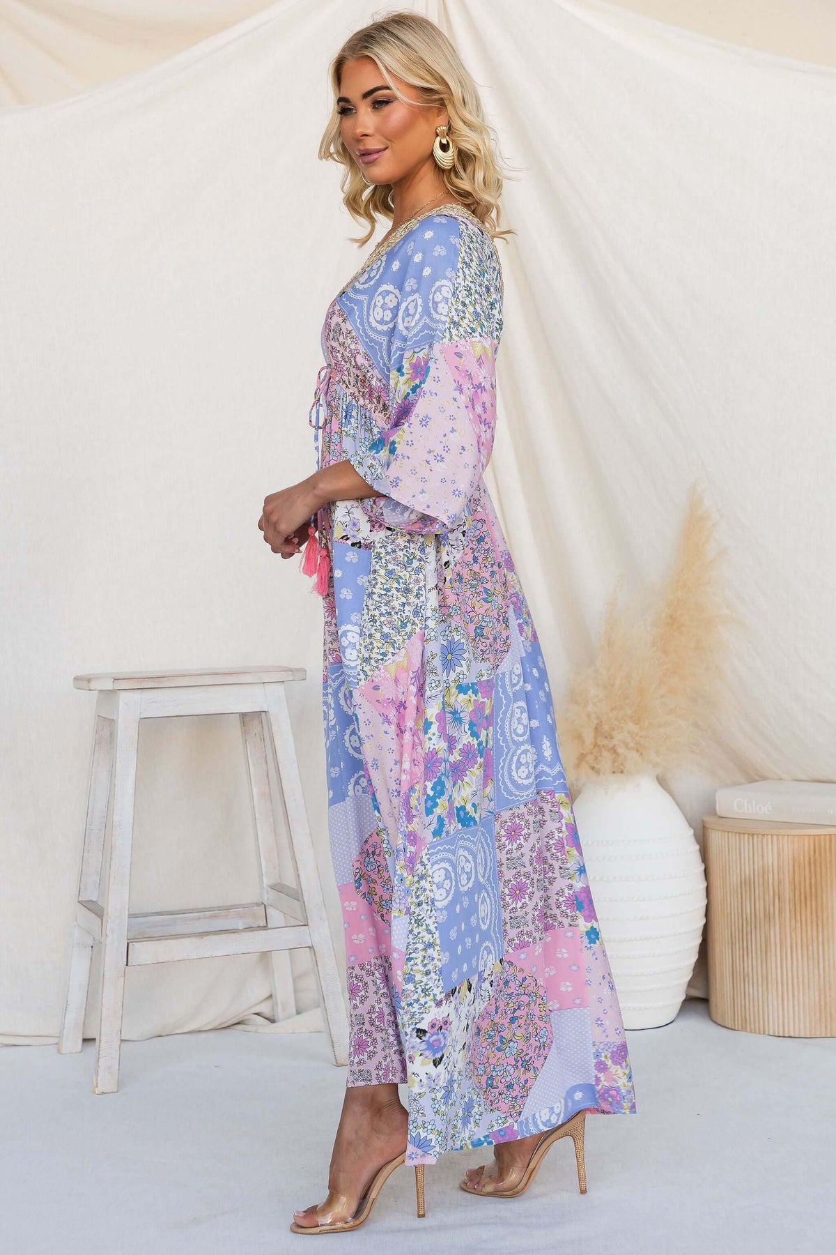 Model showcases the Endless Evening Maxi Dress with a V-neckline and pockets in a vibrant patchwork design.